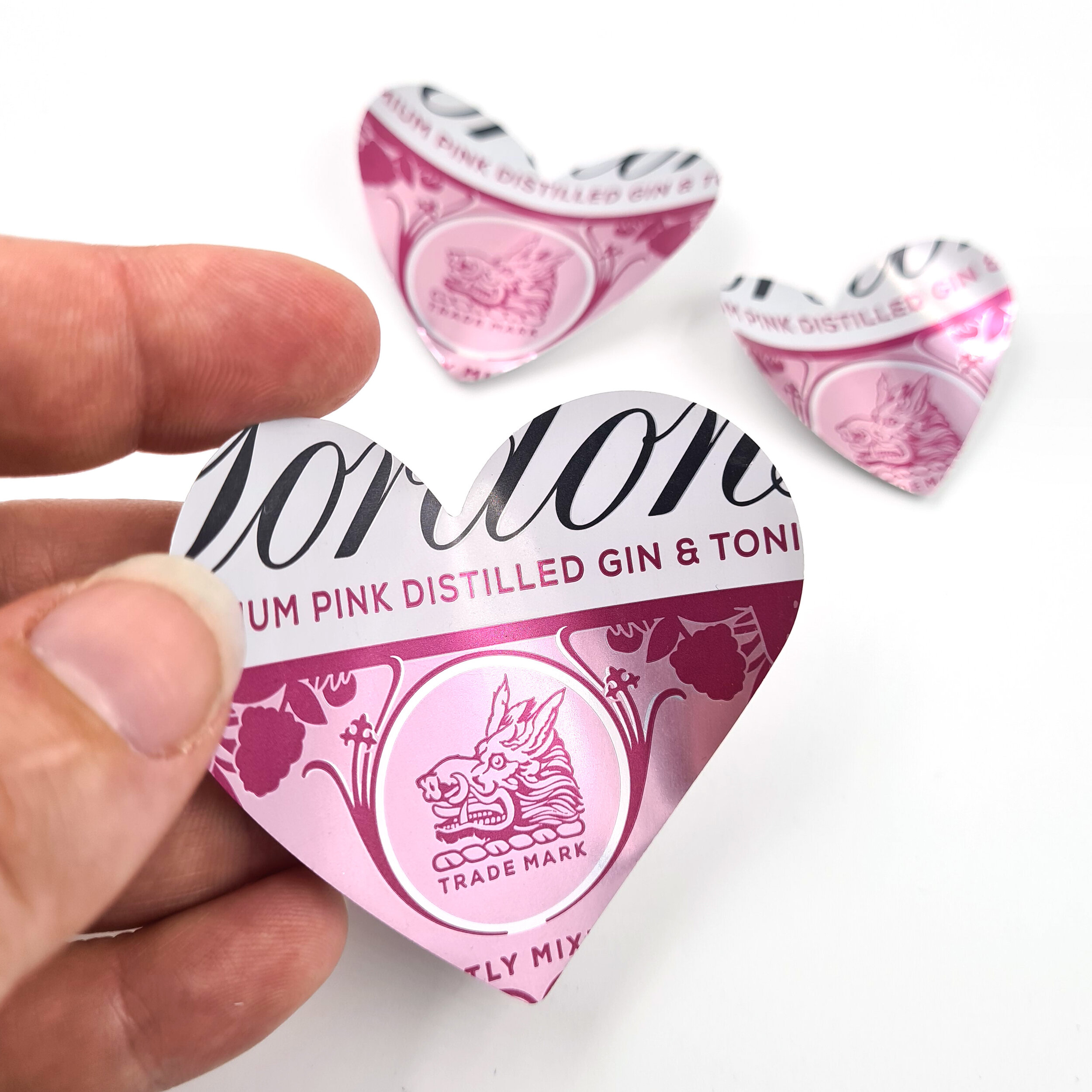 Three Pink and white Gin Heart Can Magnets holding