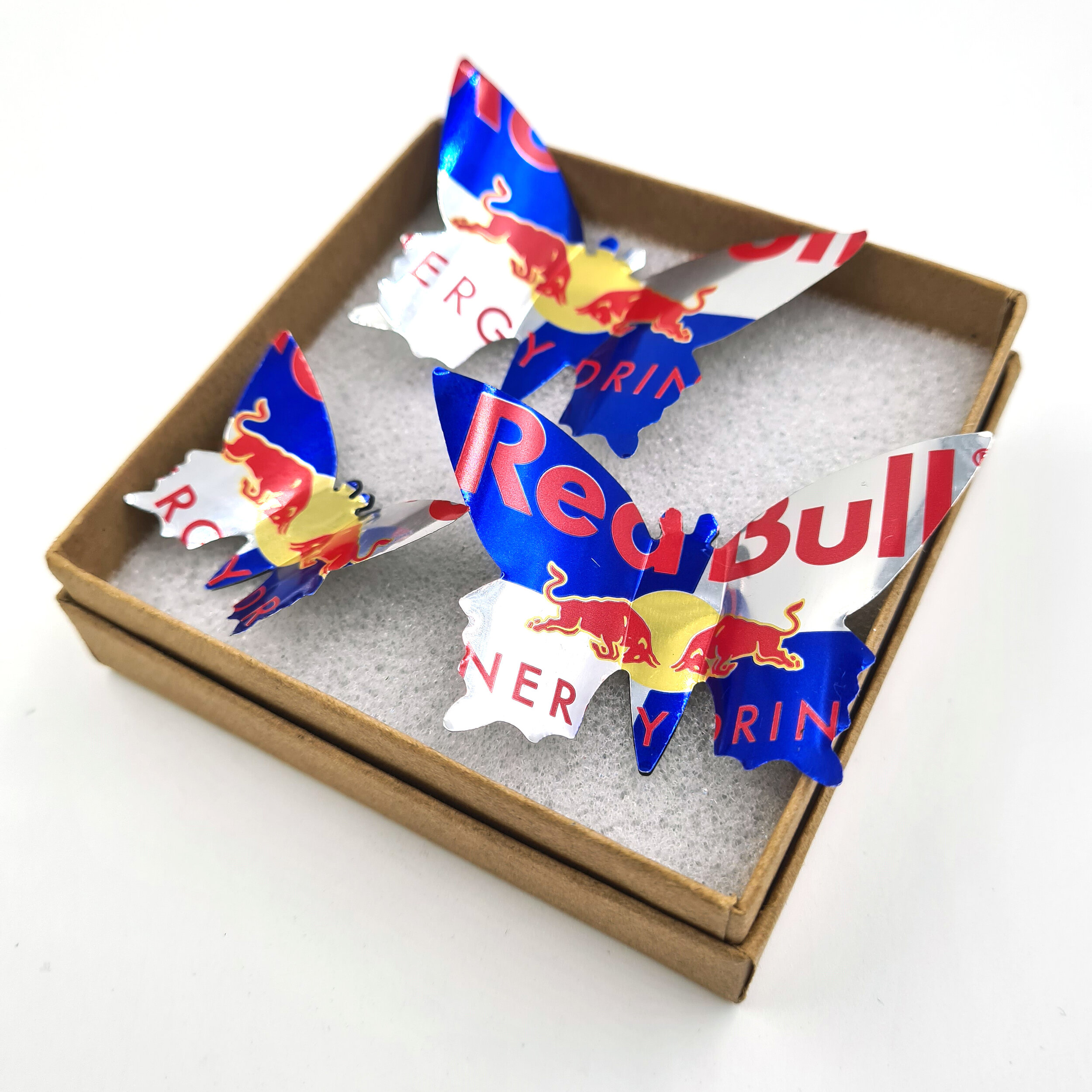 Three blue red and silver eco Redbull Butterfly Can Magnets in box