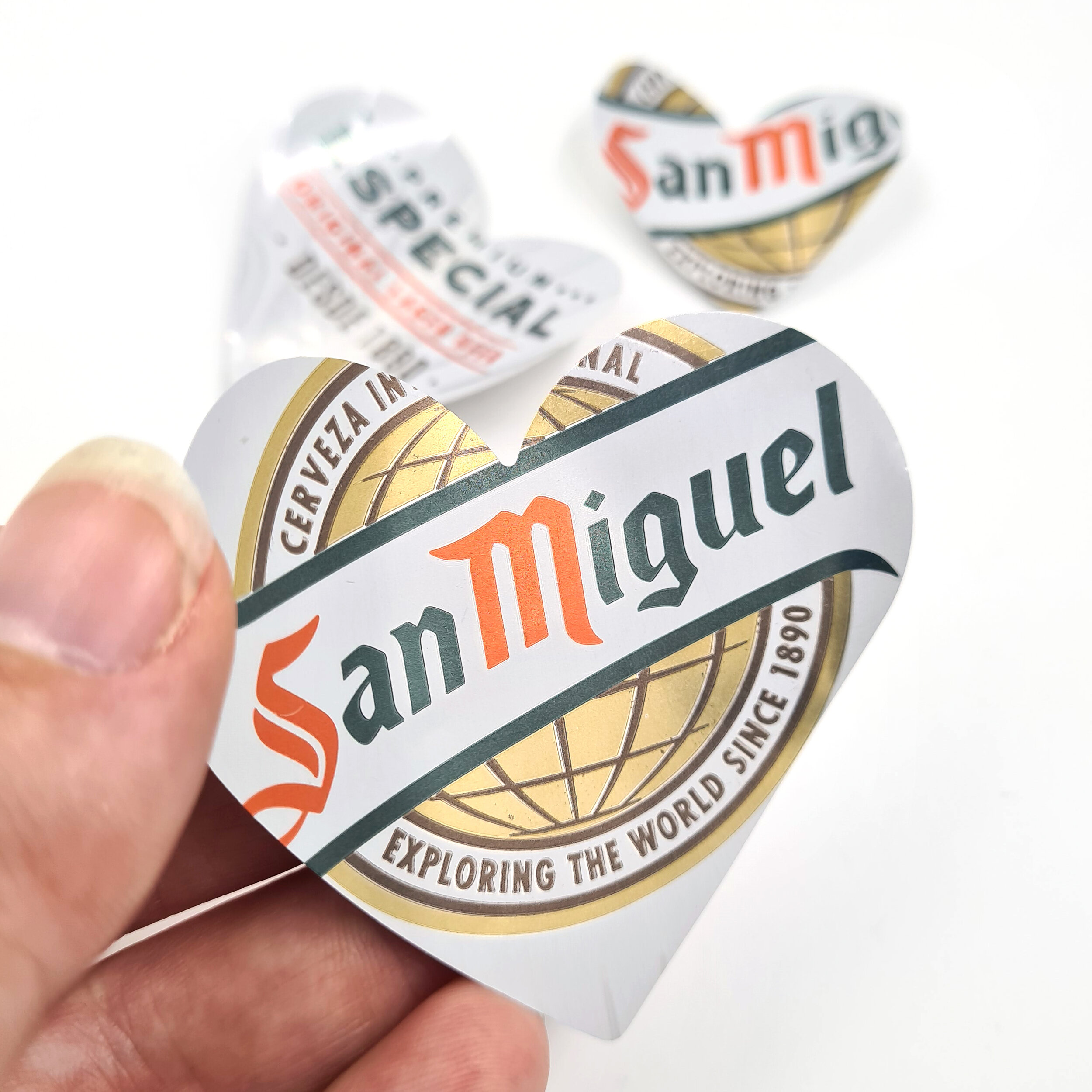 Curved gold sustainable San Miguel Heart Can Magnets holding