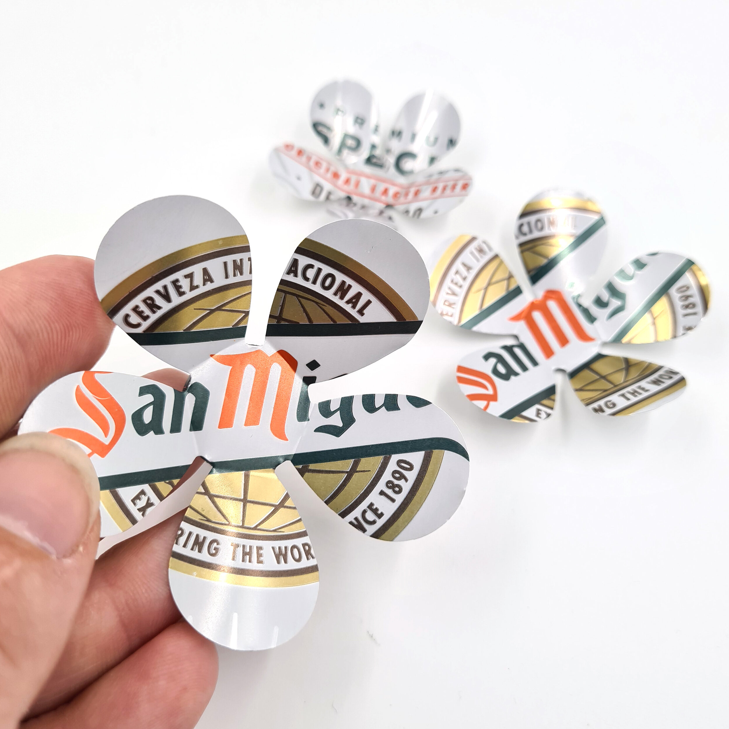 Gold eco friendly San Miguel Can Flower Magnets holding