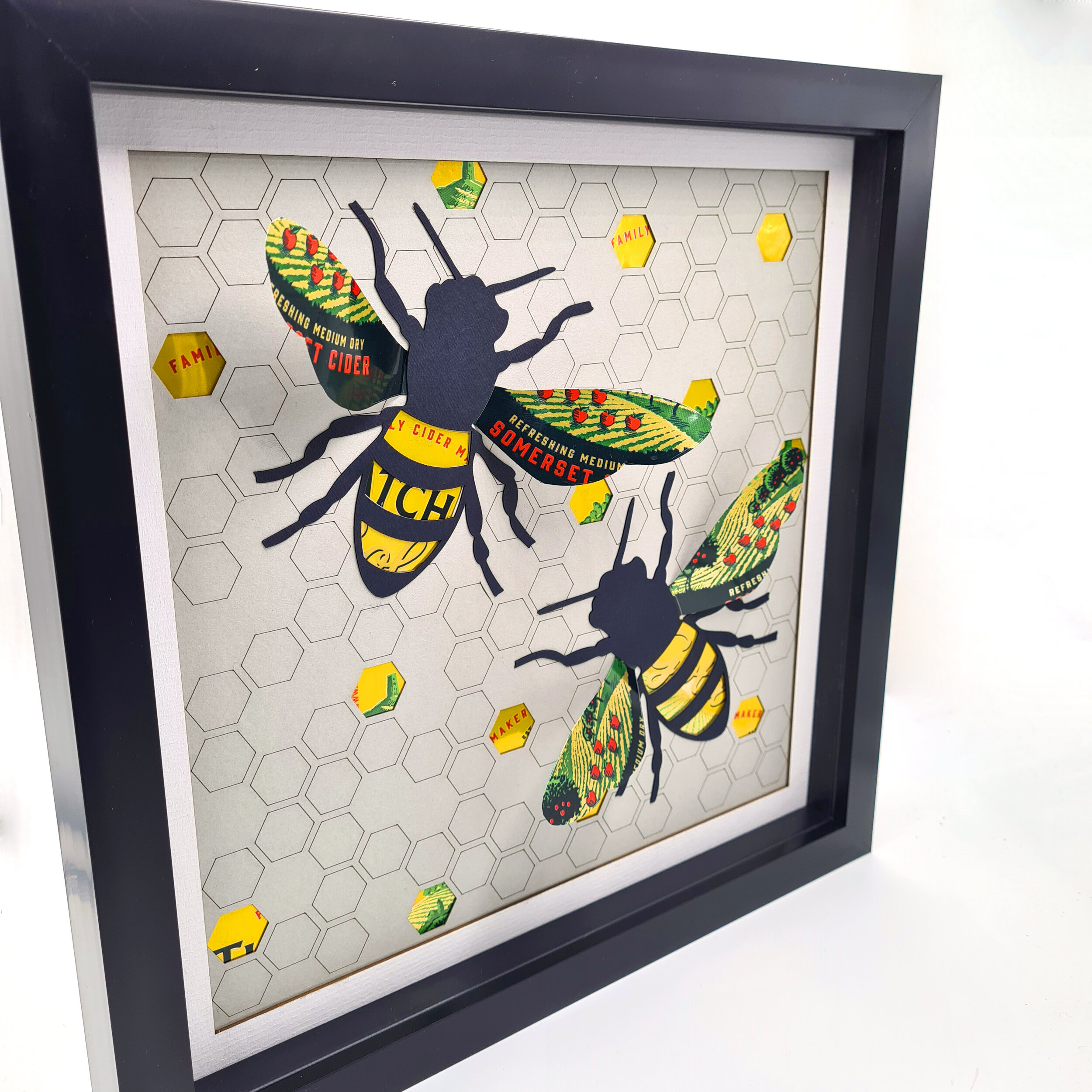 Repurposed cider cans upcycled into a bee artwork