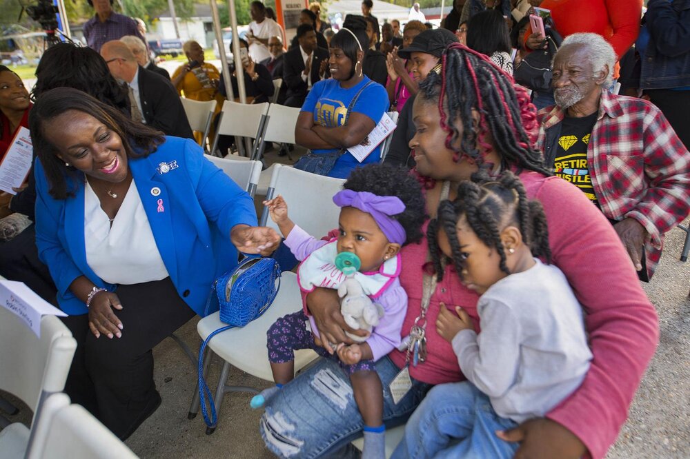  Senator Regina Barrow, left, D-Baton Rouge, chats with Ardenwood Village resident Janet Dunn, right, who holds grandchildren Maci Ruffin, 1, and Madison Ruffin, 2, at the U.S. Dept. of Housing and Urban Development (HUD) gathering to celebrate the $