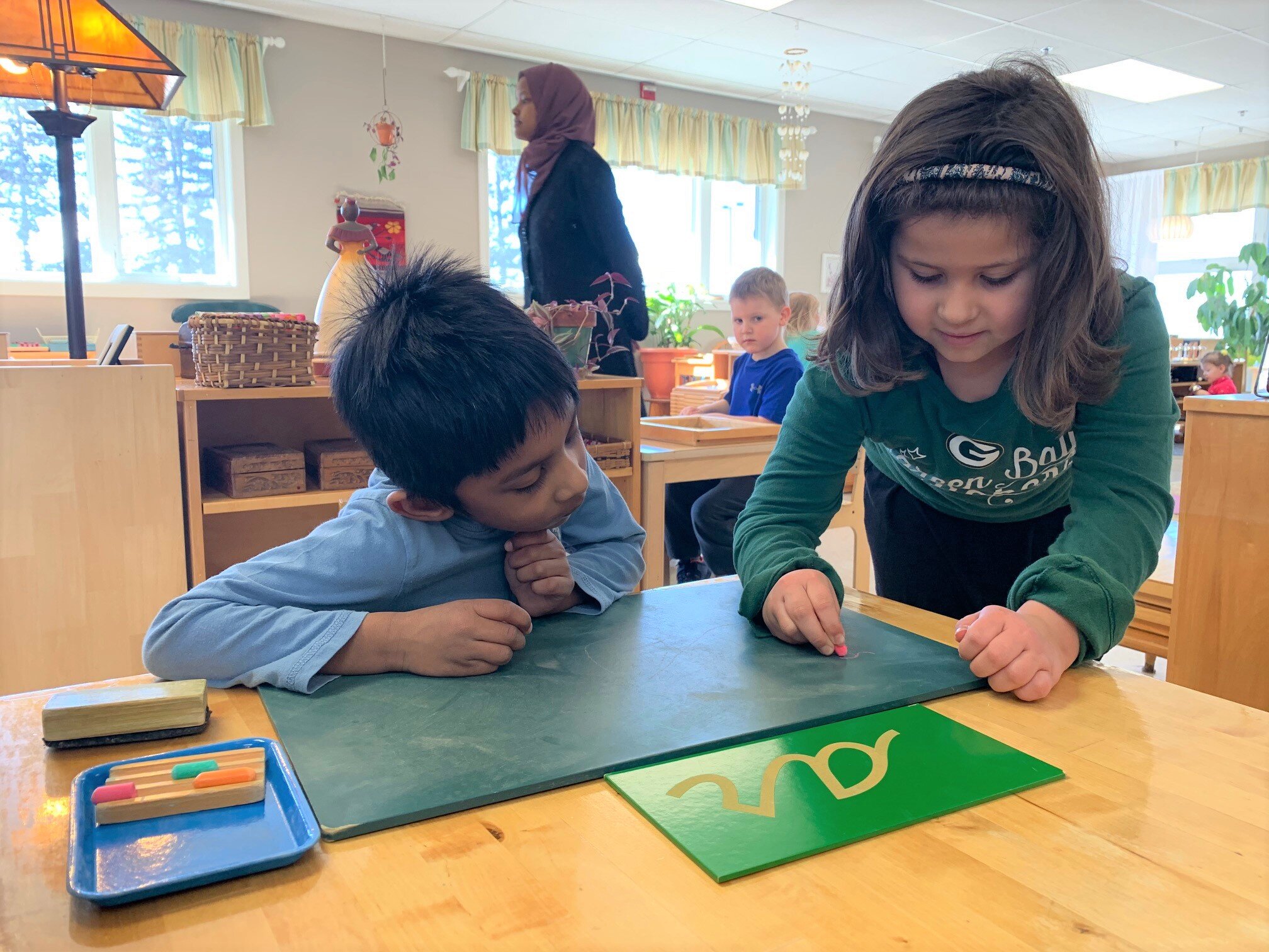 Hazel Helping Haroon with Chalkboard.jpg