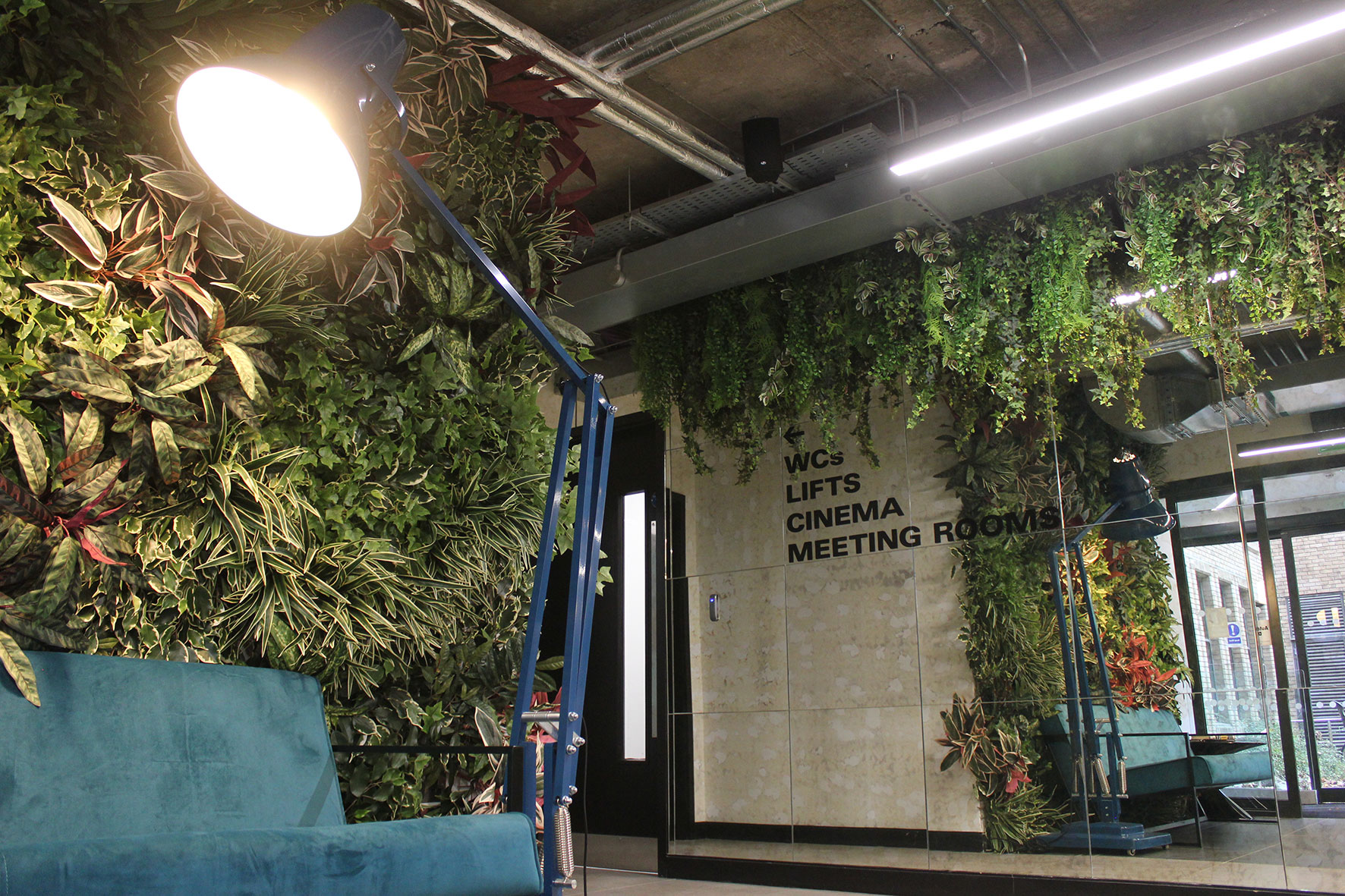 Lush plantings at The Greenway integrate live, artificial plants and vertical living gardens throughout.