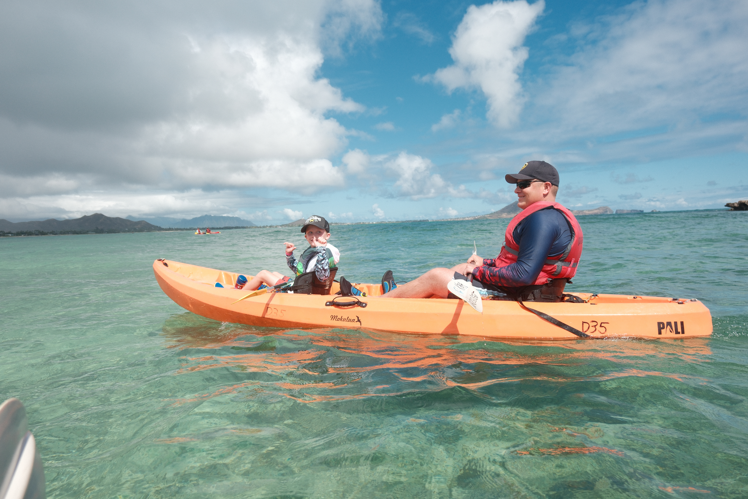 Dad and son kayaking with the family in kailua