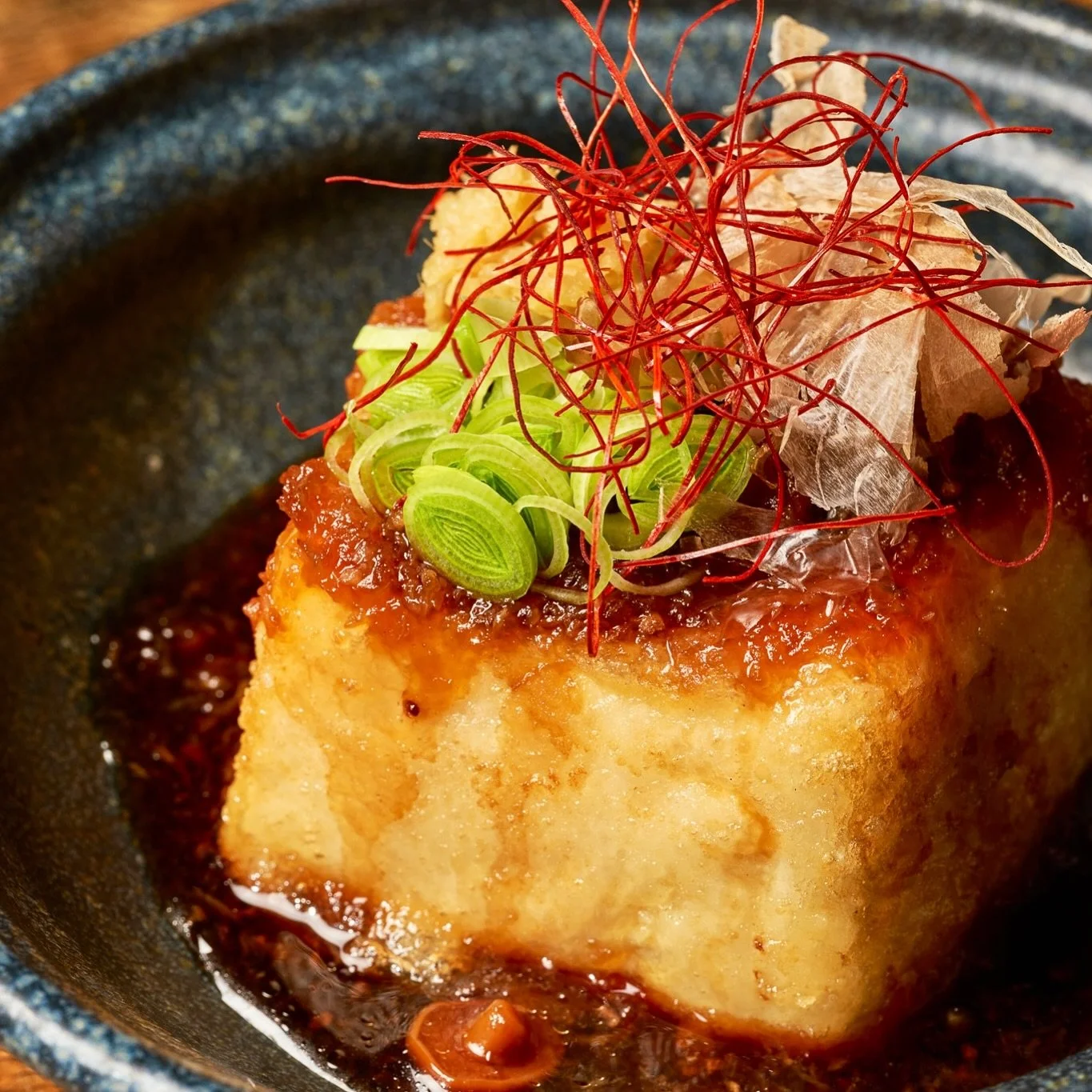Agedashi Tofu ✨ Golden, crispy silken tofu served in a rich, savory dashi broth. Topped with fresh daikon, ginger, earthy nameko mushrooms, and delicate bonito flakes for the perfect balance of flavor and texture.

A comforting Japanese classic that 