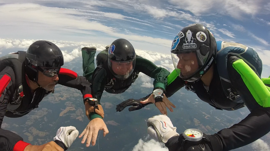 Eli (far right) builds a base on an 8-way relative work formation skydive. Photo courtesy of Erin Kruth.