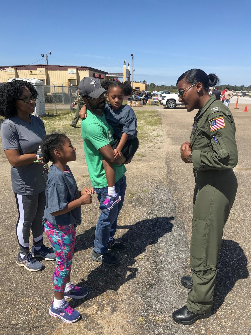  Coast Guard pilot Angel Hughes invites a participant to visit her airplane during a youth flight camp in Tuskegee, AL.  Photo courtesy of Danielle Williams   