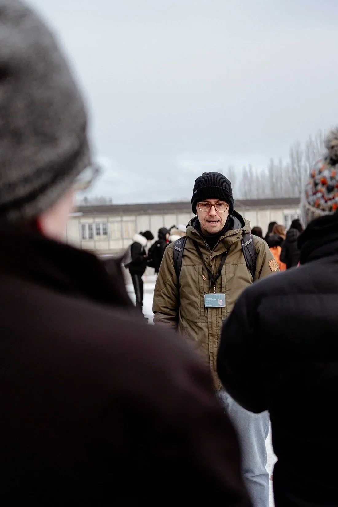 Licensed guide leading a small group during a guided visit at the Dachau Memorial Site.