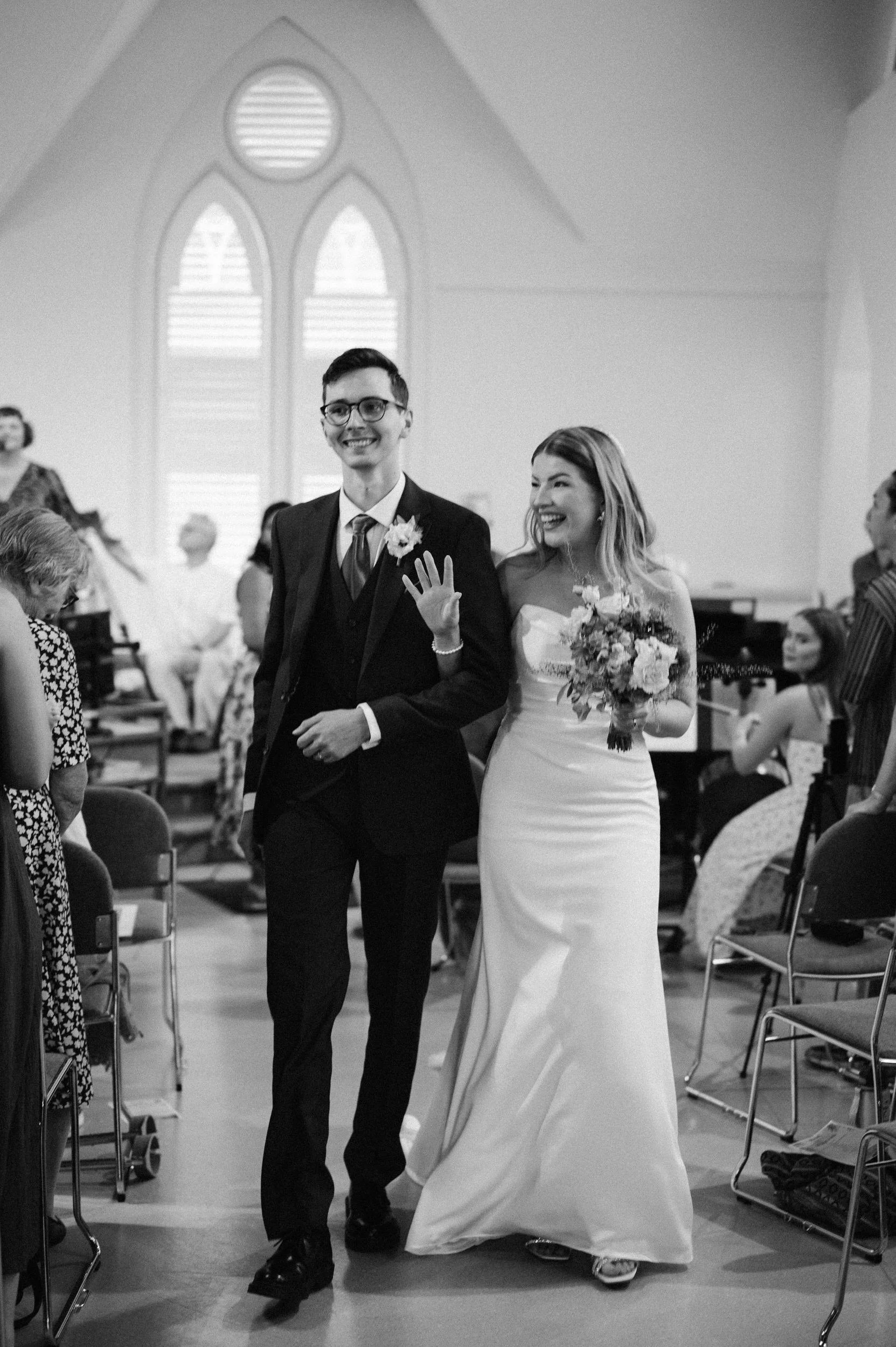 bride and groom walking down the aisle at sutton coldfield baptist church