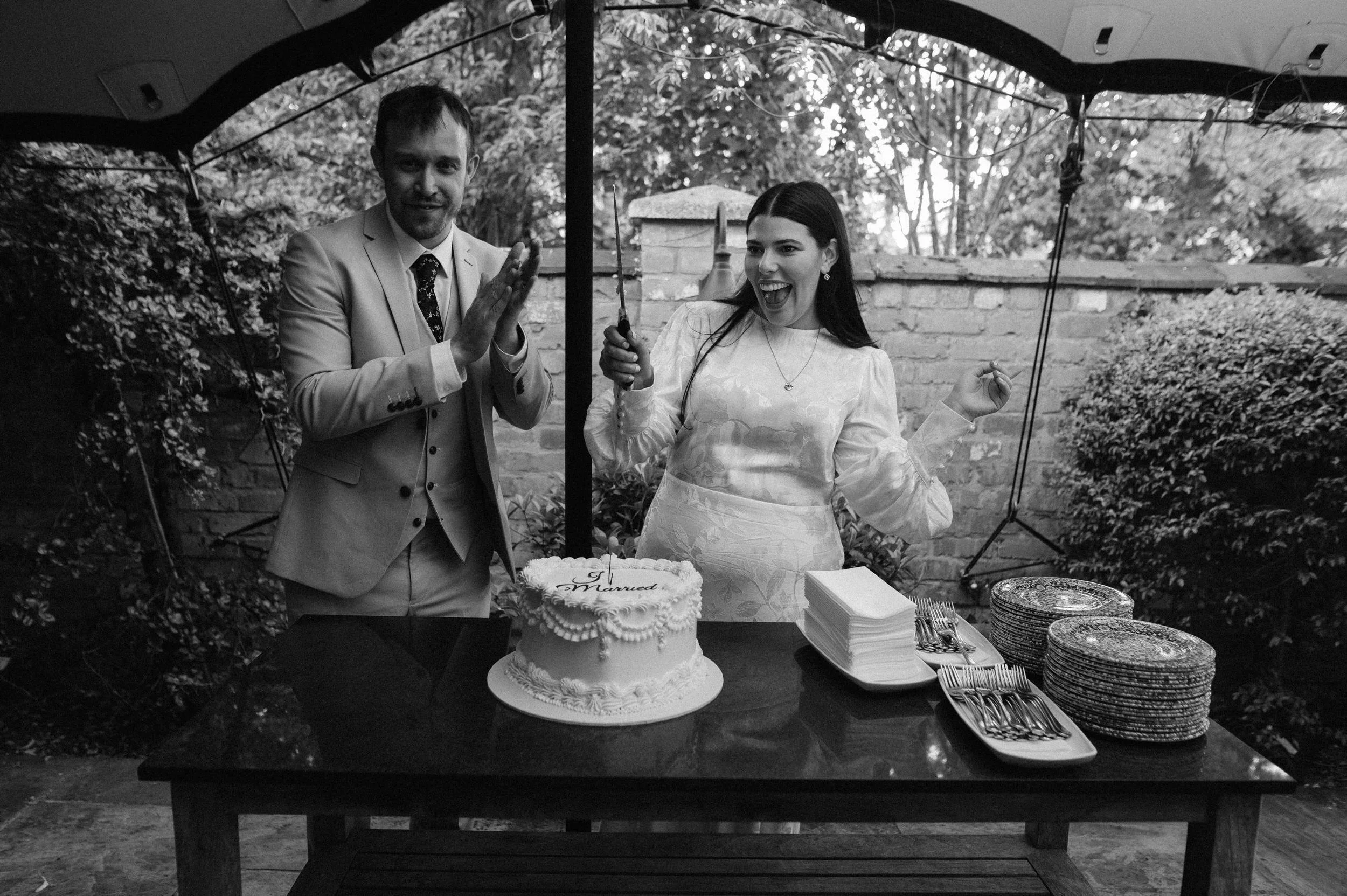Cutting the cake during an intimate Edgbaston wedding reception