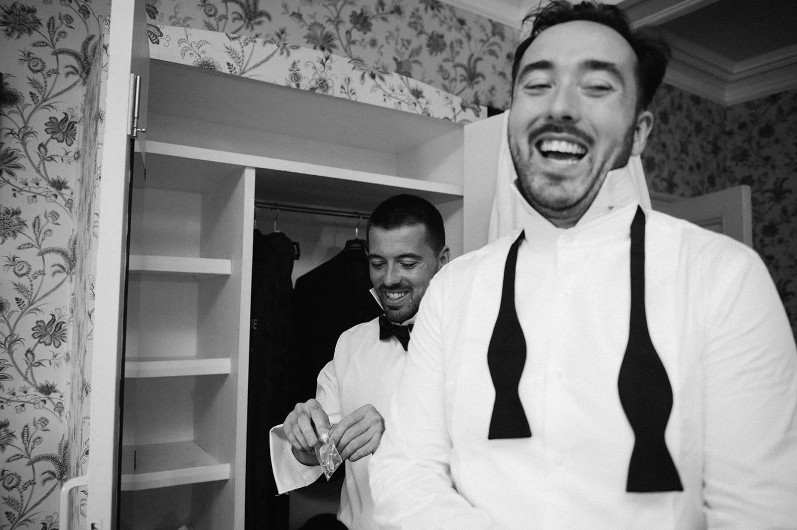 Groom tying bow tie at Halecat House wedding