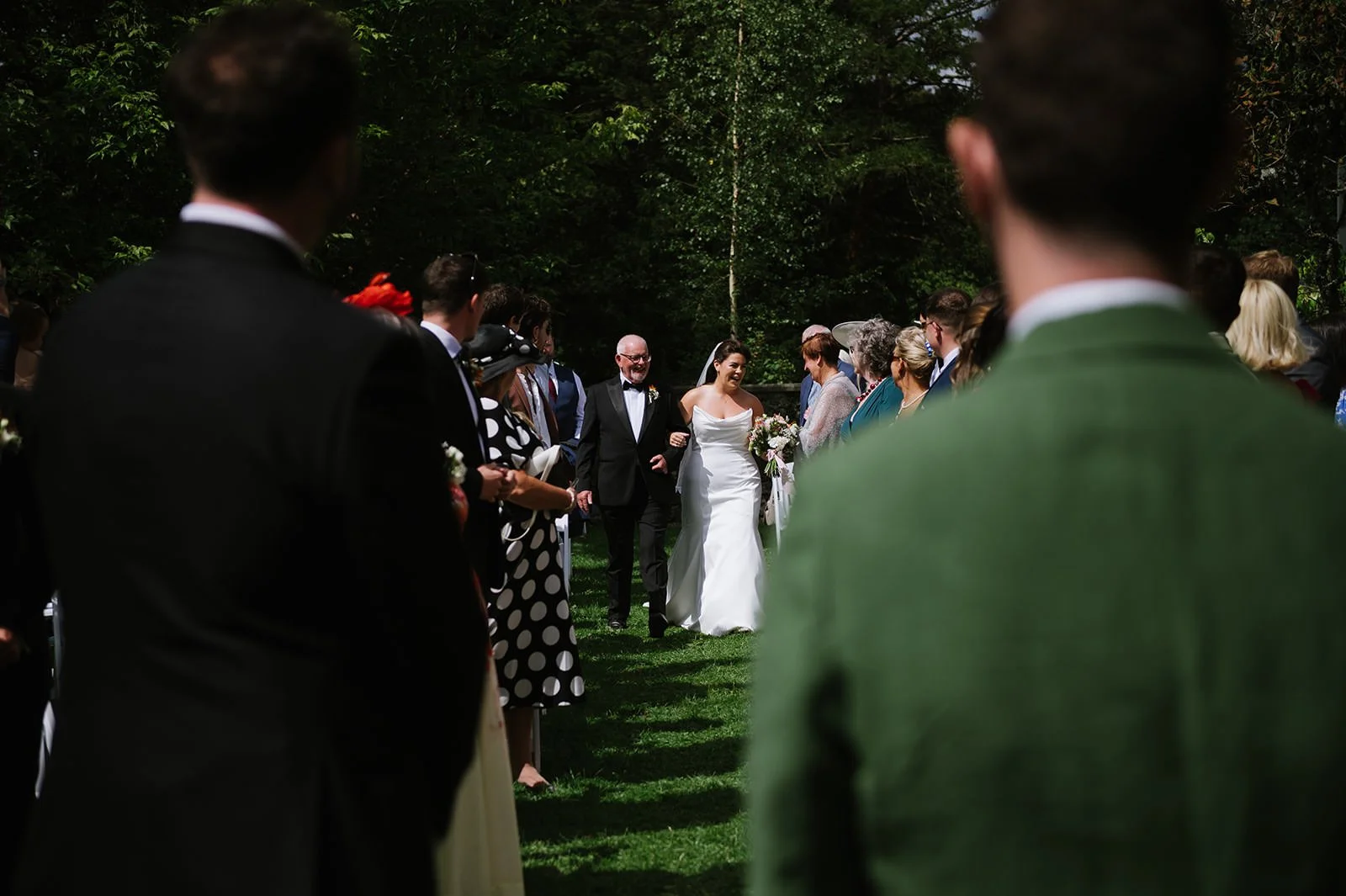 Bride walking down aisle in sunken garden ceremony space