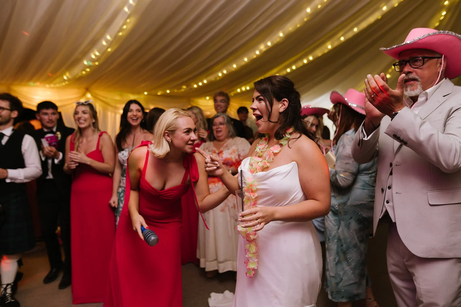 Bride reacting to groom joining band on guitar