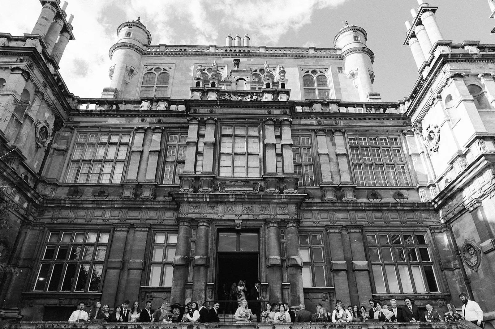 Full group wedding photo on the steps of Wollaton Hall
