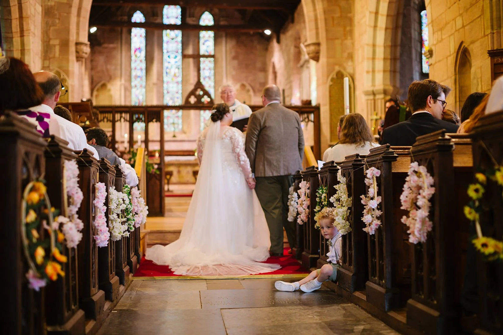 Church wedding ceremony with children playing at the back