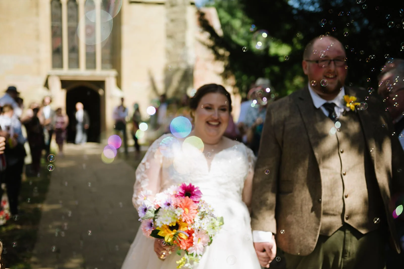 Bubble exit after a relaxed church wedding ceremony