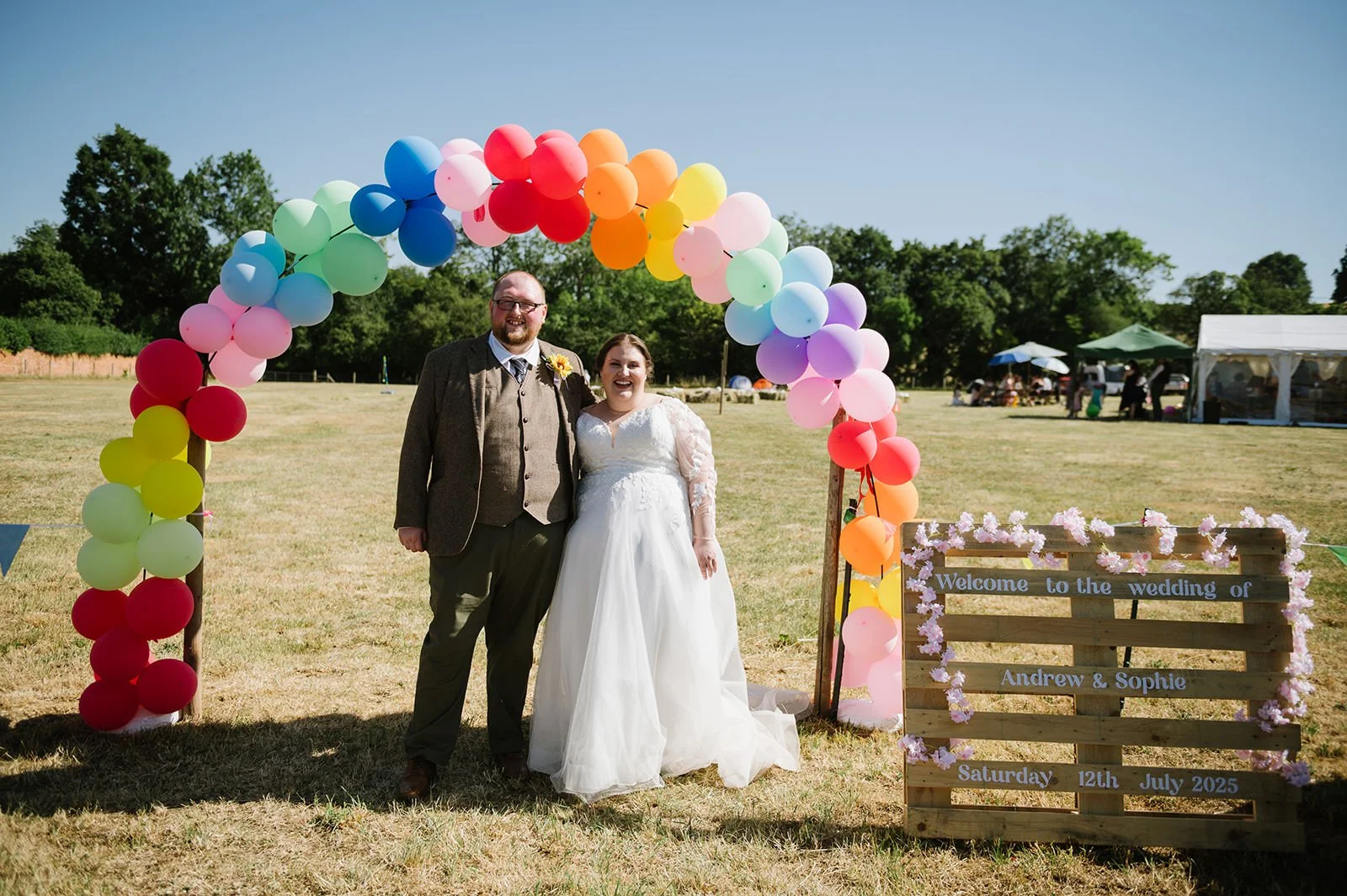 Balloon arch entrance at a summer field wedding