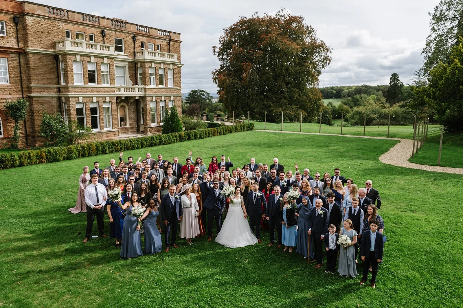 Group wedding photo on the lawn at Bredenbury Court Barns