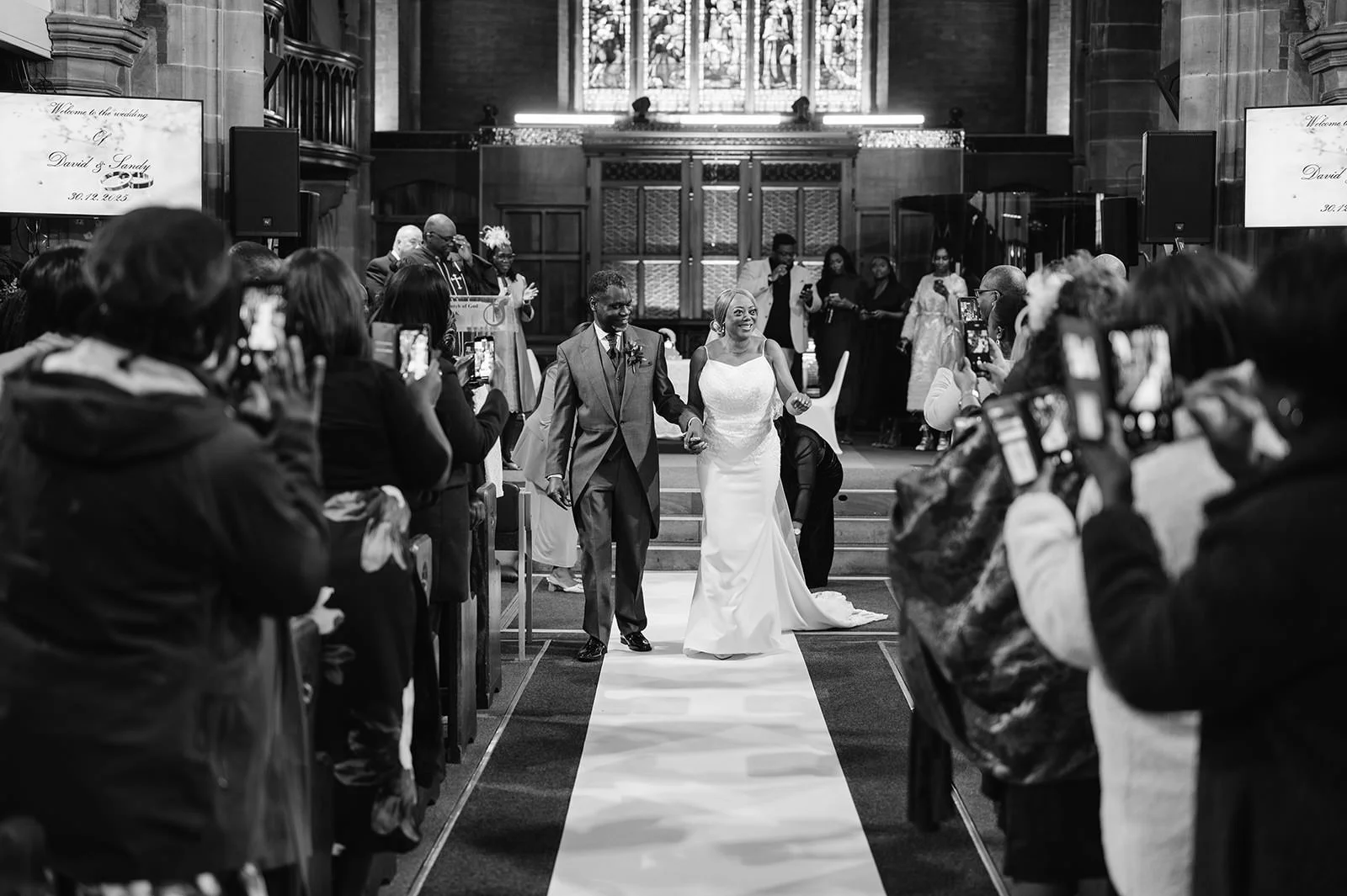 Bride and groom walking down aisle at church wedding