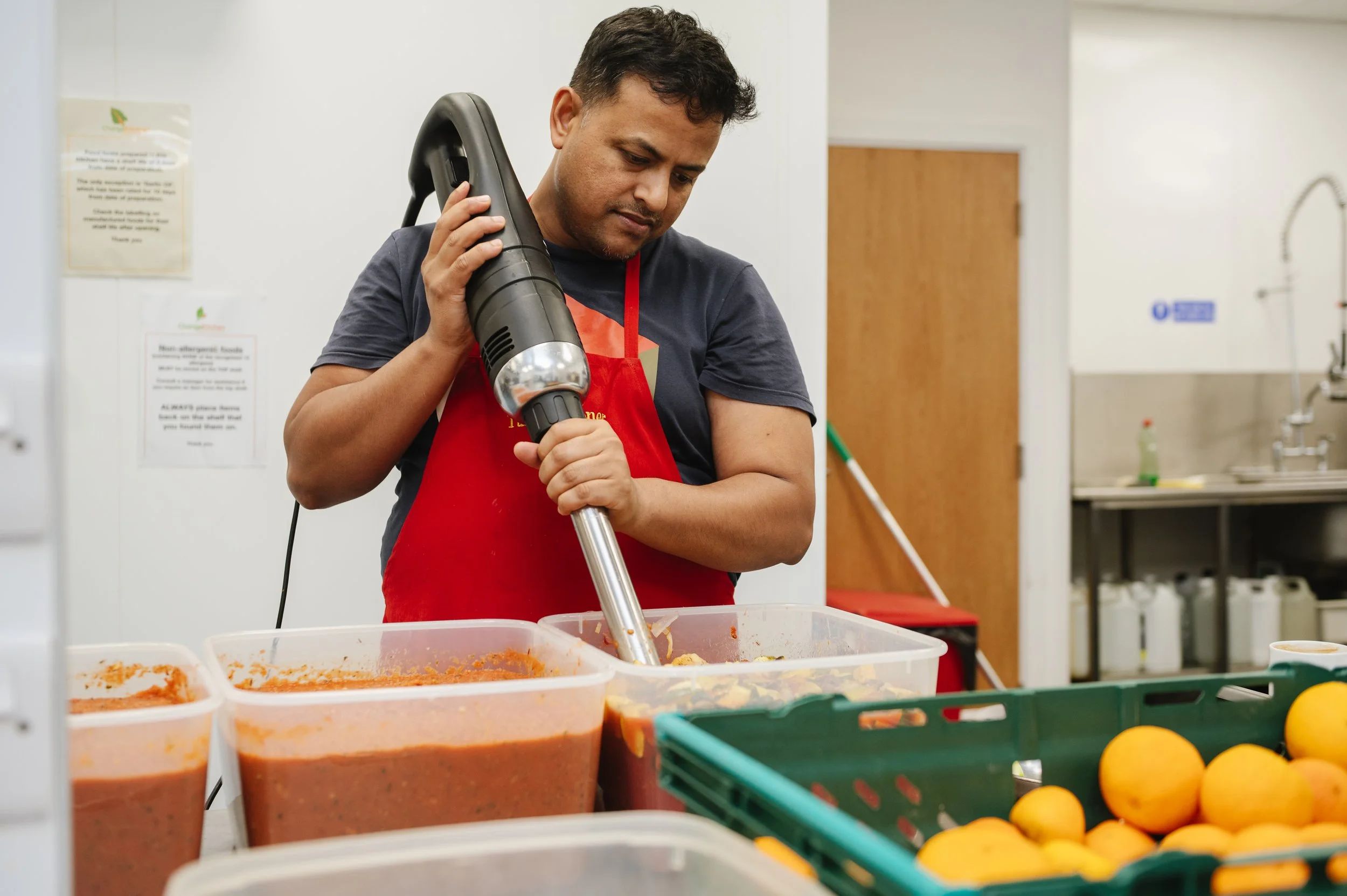 Commercial kitchen staff preparing food for social enterprise catering service