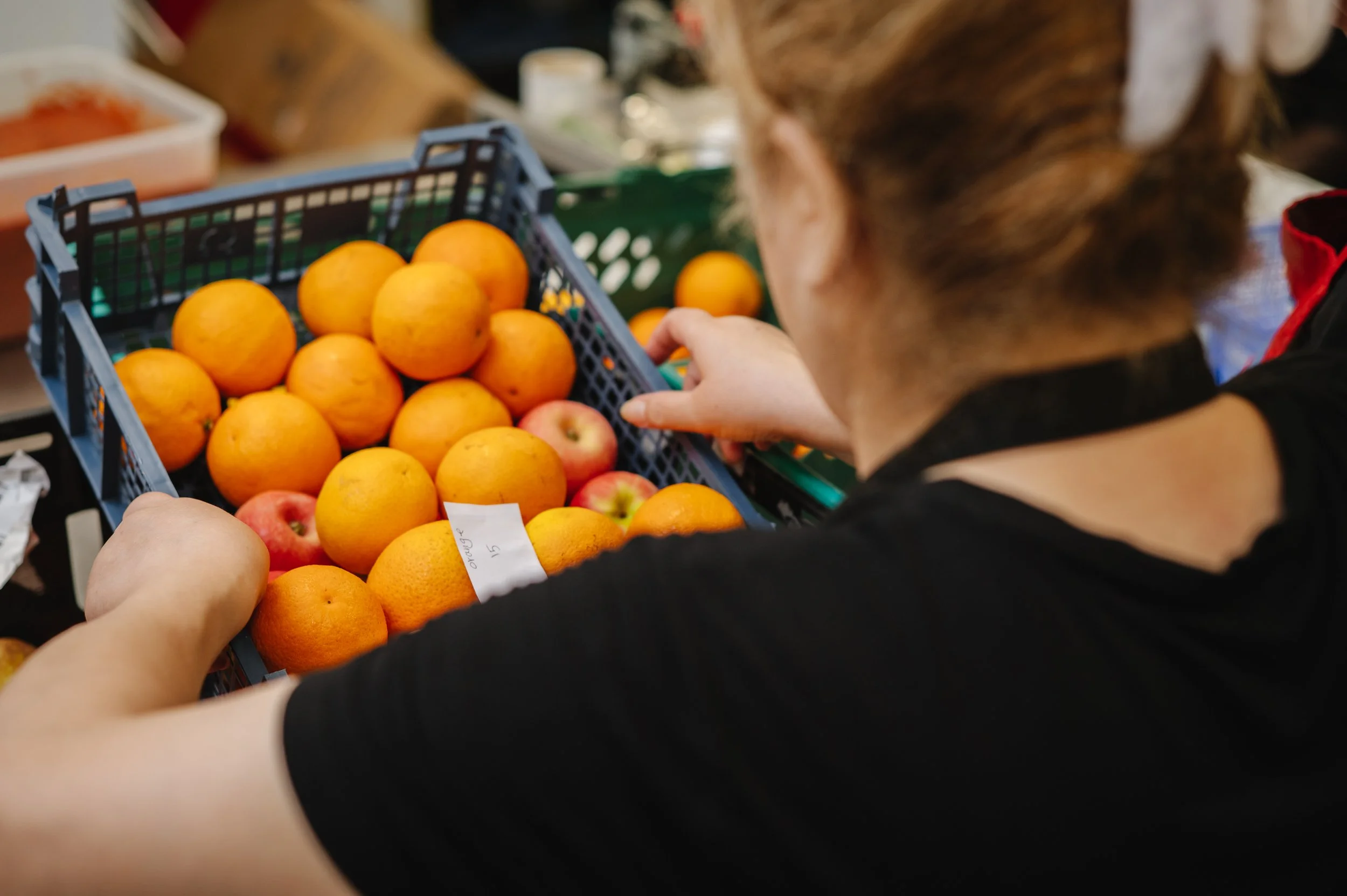 Commercial kitchen staff preparing food for social enterprise catering service