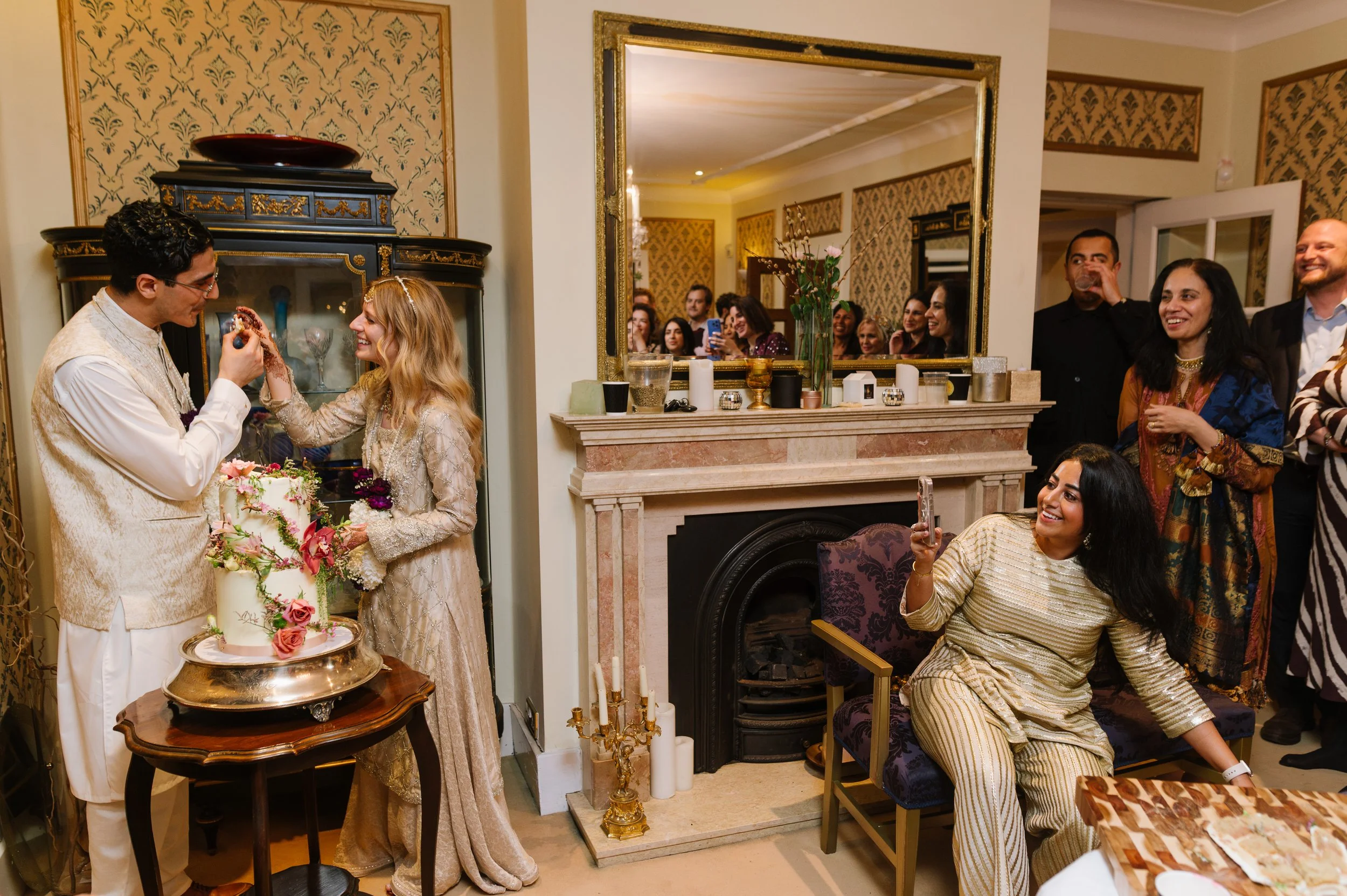 bride and groom cut the cake at their home nikah celebration in birmingham