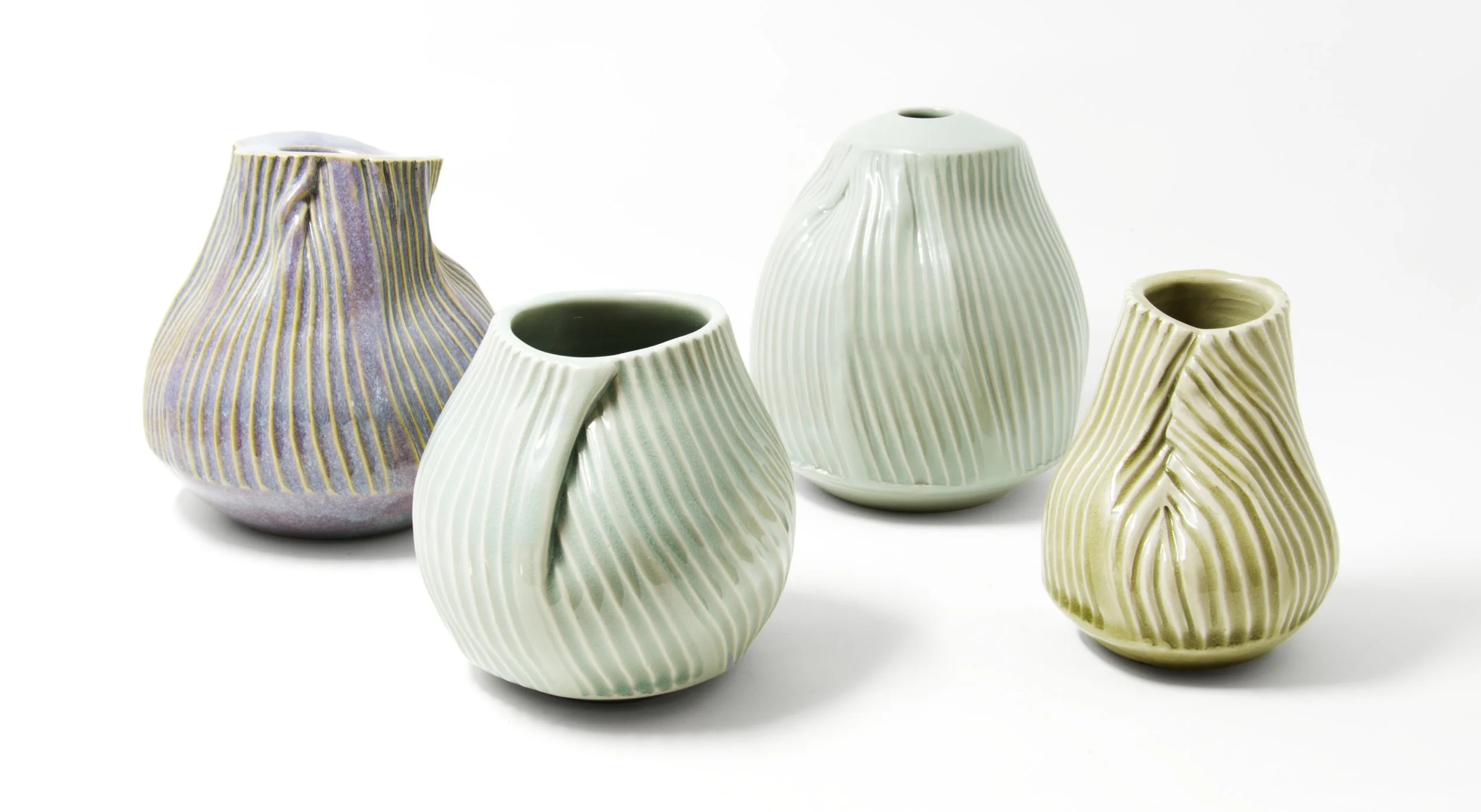 Exploring the relationship between form, movement, and material, Mary Jaffe folds and shapes clay into vessels that feel both architectural and organic. Each work reveals the artist’s hand through its layered surfaces, graceful curves, and beautiful