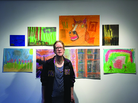  Heidi standing with her pastel work at her solo show 