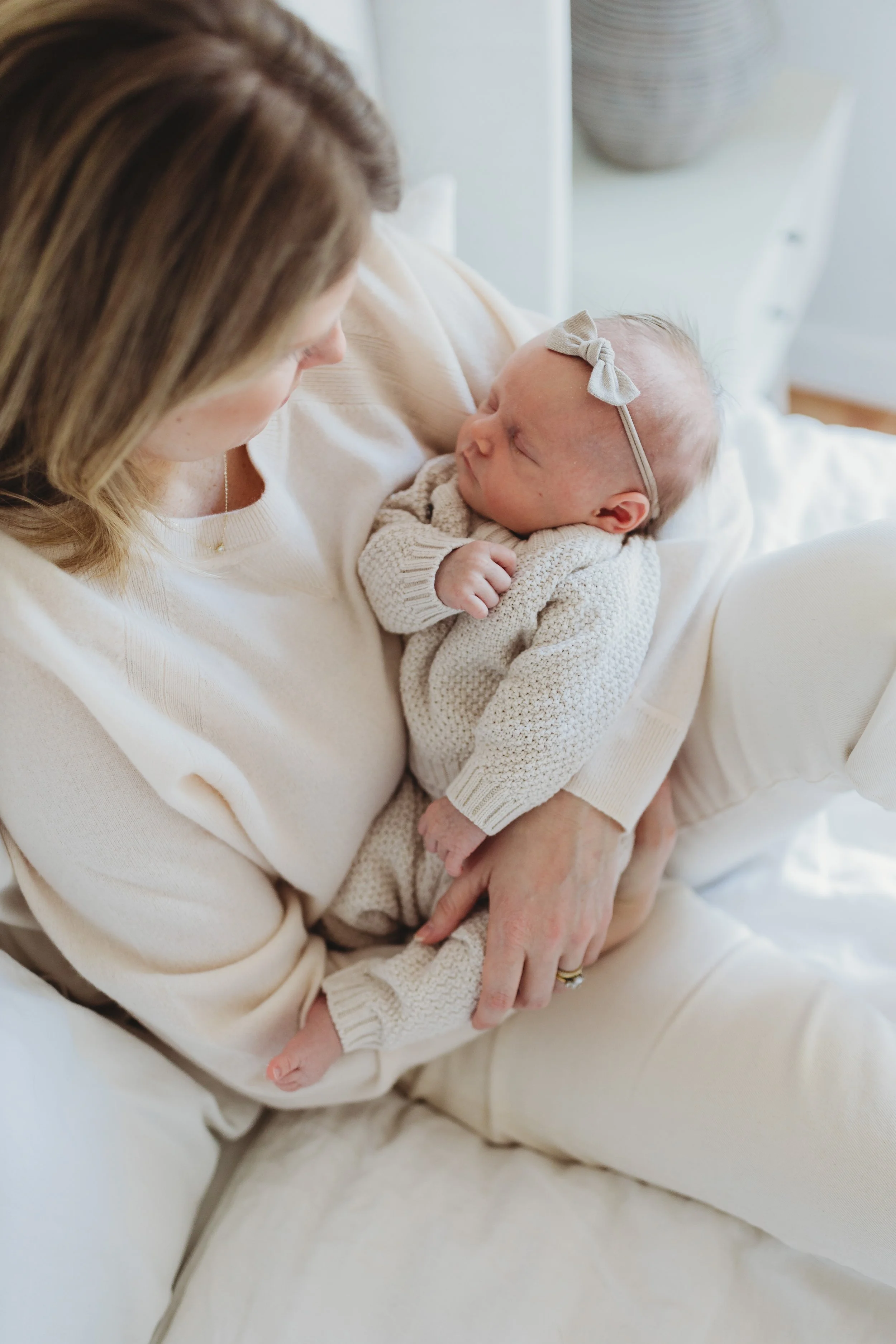 Mother holding newborn baby during in-home lifestyle newborn session in Seattle