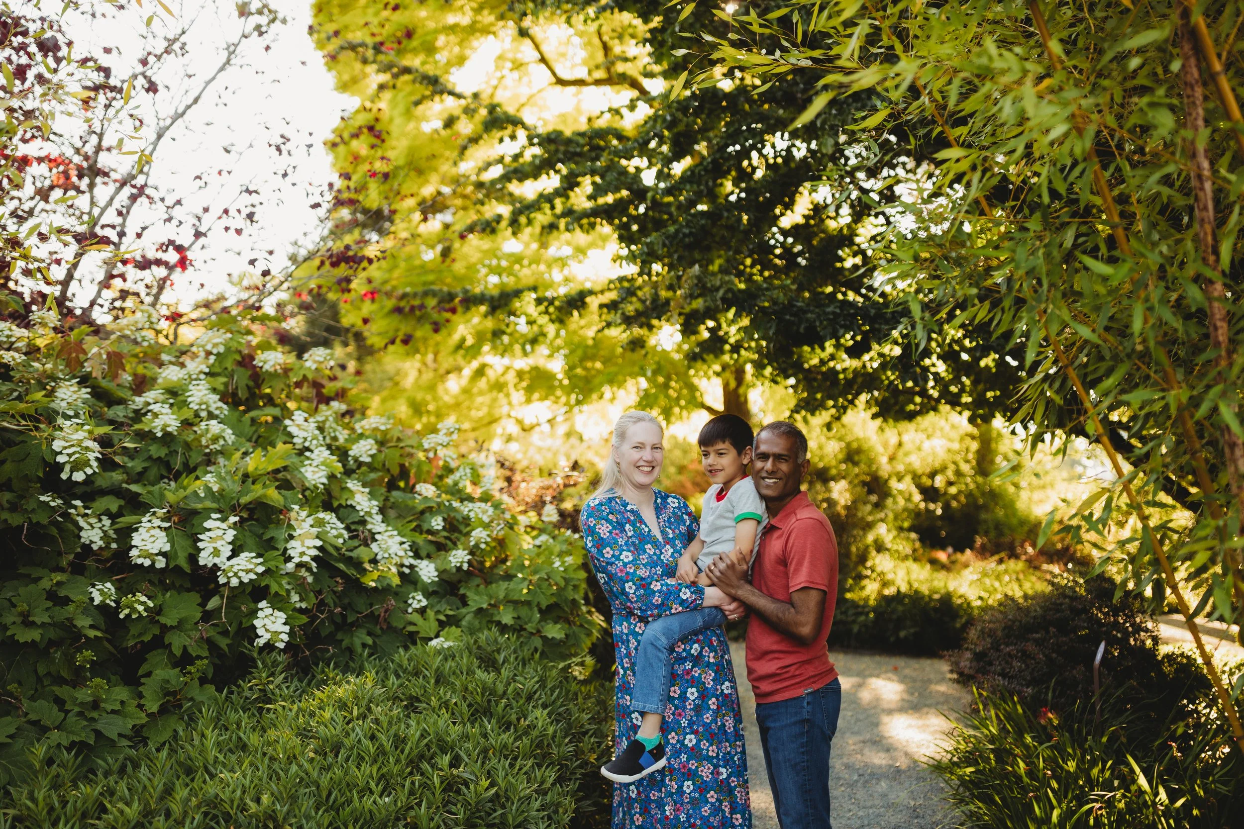Family photo session at Bellevue Botanical Garden featuring lush greenery, garden paths, and soft natural light.