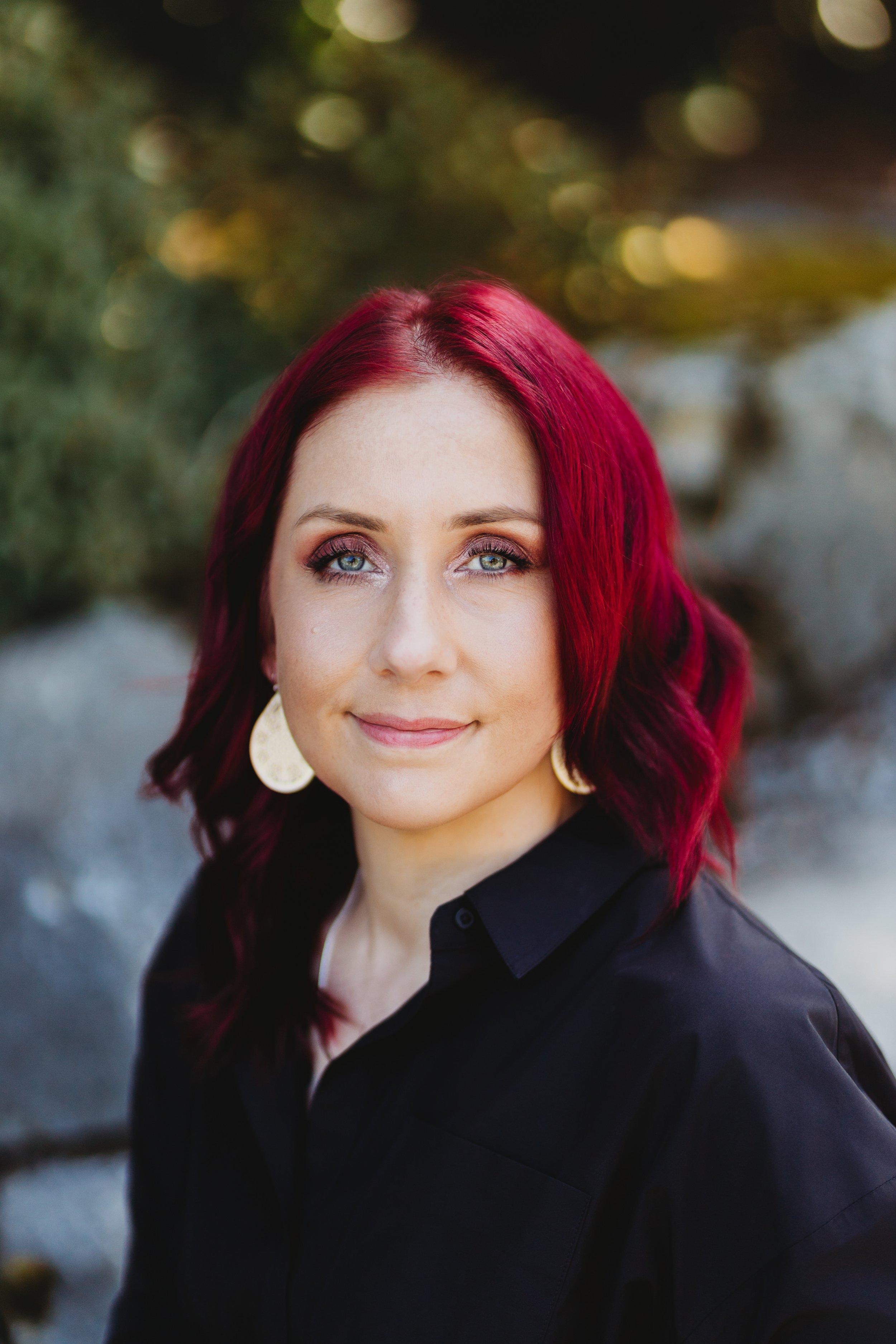 A confident, approachable professional headshot photographed in natural light in Bellevue Botanical Garden. This portrait feels polished, relaxed, and timeless—ideal for LinkedIn and personal branding.