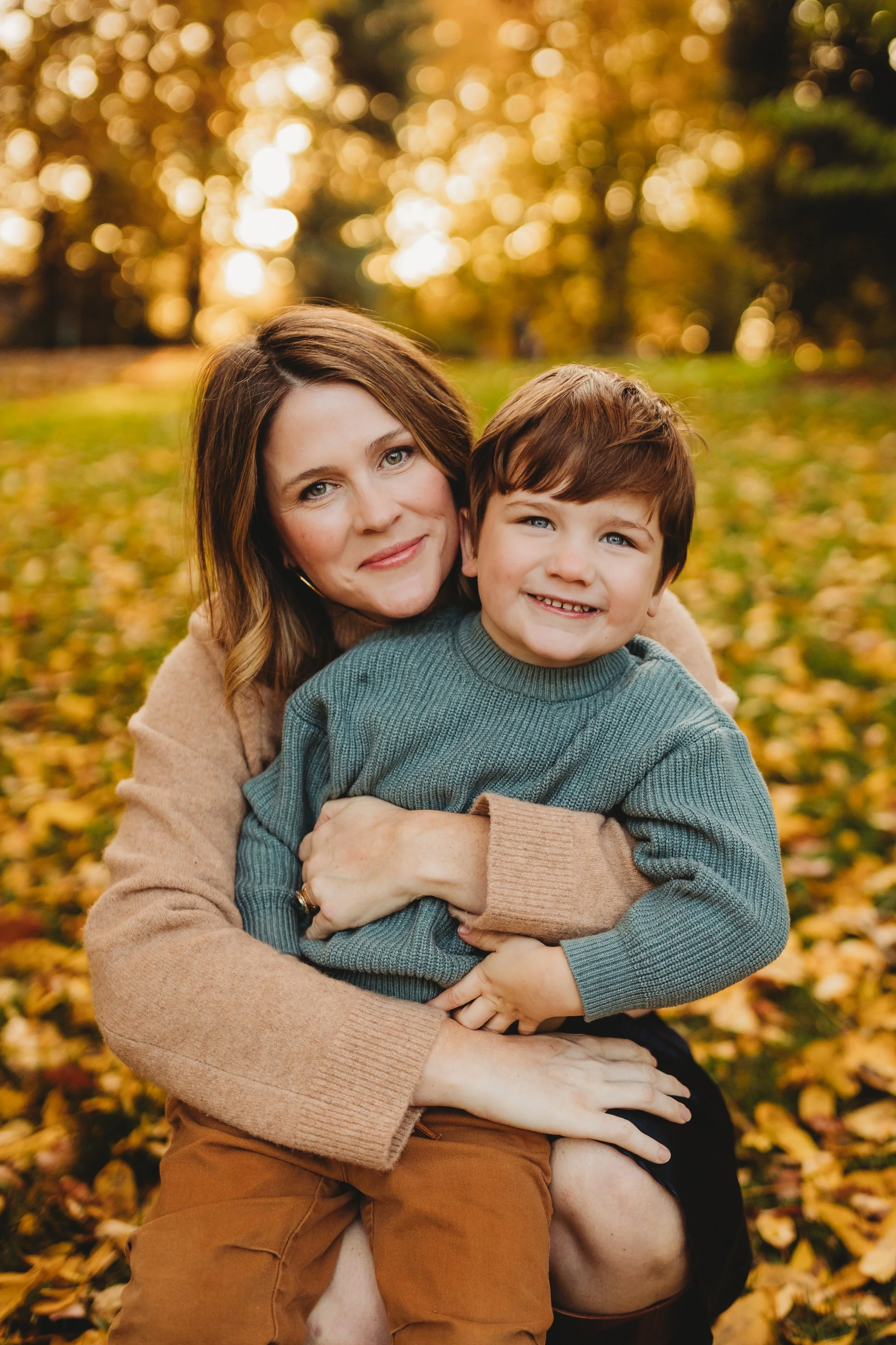 Mother hugging her young son during a fall family photo session in Seattle