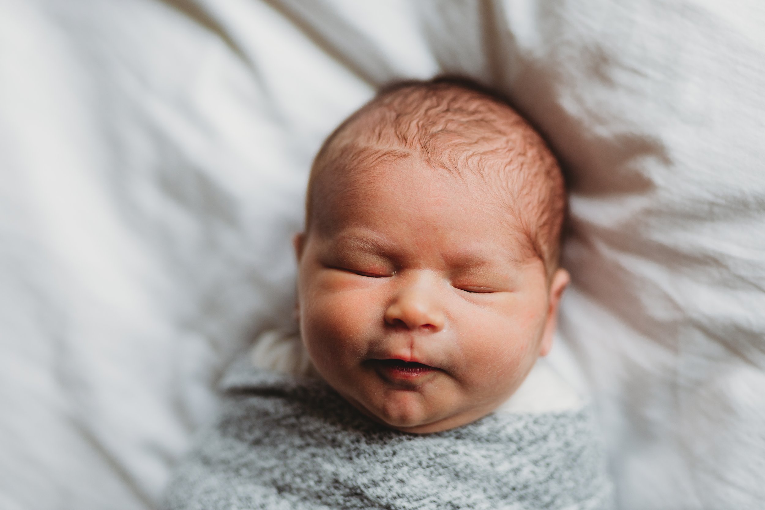 Sleeping newborn photographed during a calm, in-home newborn session in Seattle.