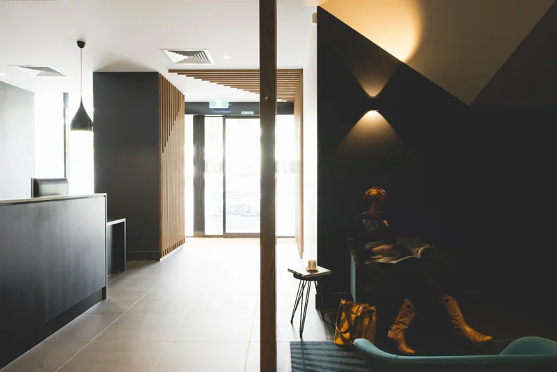 The waiting zone is tucked away with a screen between reception and waiting for privacy to both clients and employees. A choice of chair types allows people to be active or resting. This one is the quiet reading zone.