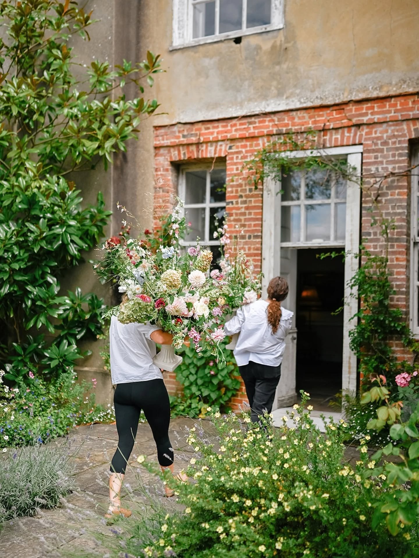 More of what happens behind the scenes with team Dove &amp; Myrtle.  This time caught in action by the amazing @wolfshootsweddings moving ceremony urns inside to dress window recesses in the Stone Hall for N&amp;K's evening banquet while they and the