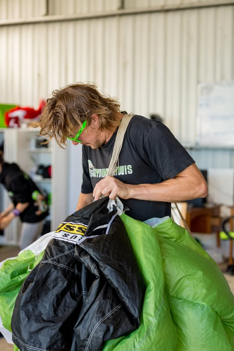  a team of parachute packers will work tirelessly throughout the day