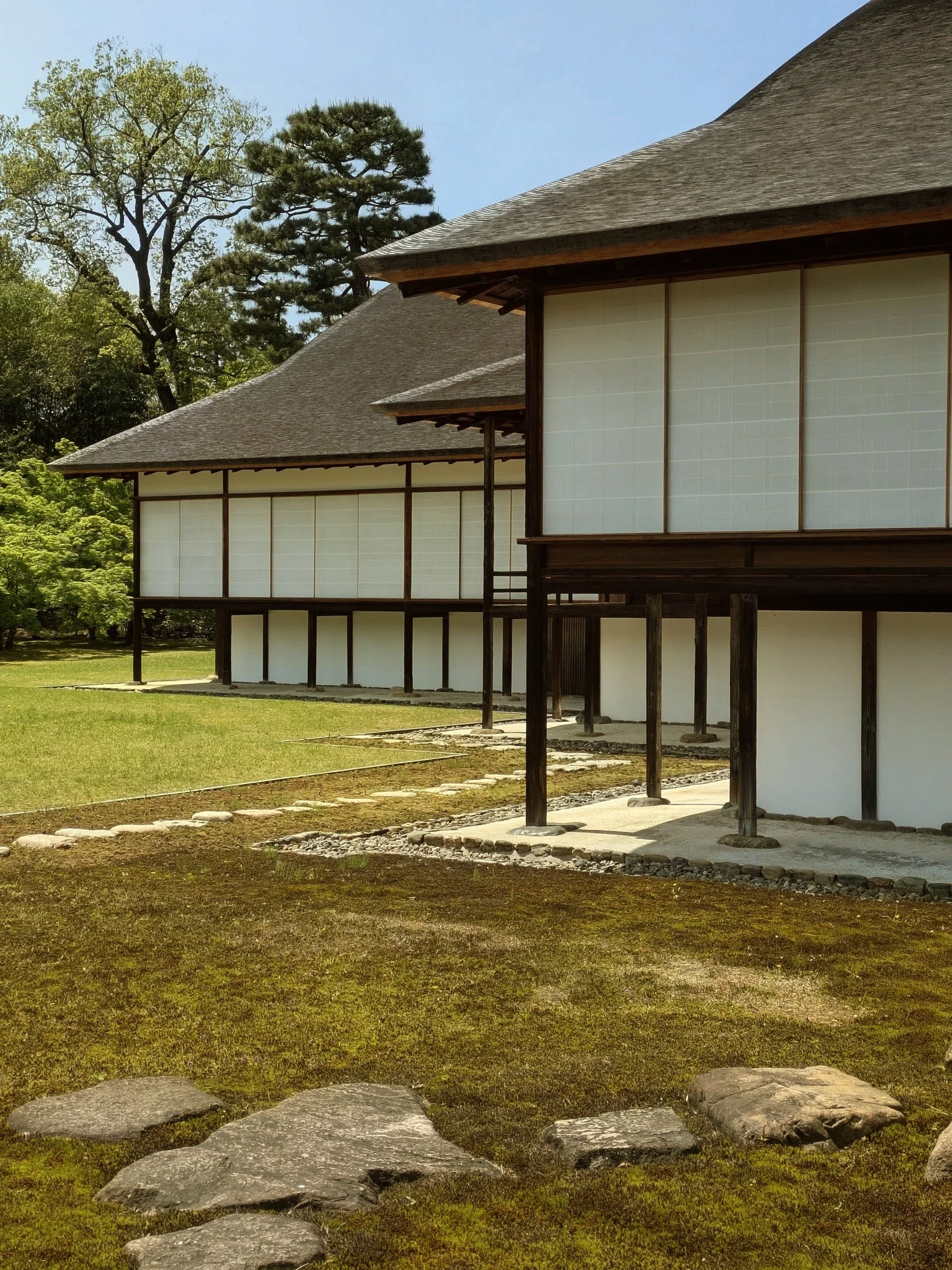 Temple engawa veranda, light and shadow across timber Engawa veranda of a Japanese Zen temple, late morning light filtered through shoji screens and falling as geometric shadows across aged timber boards
