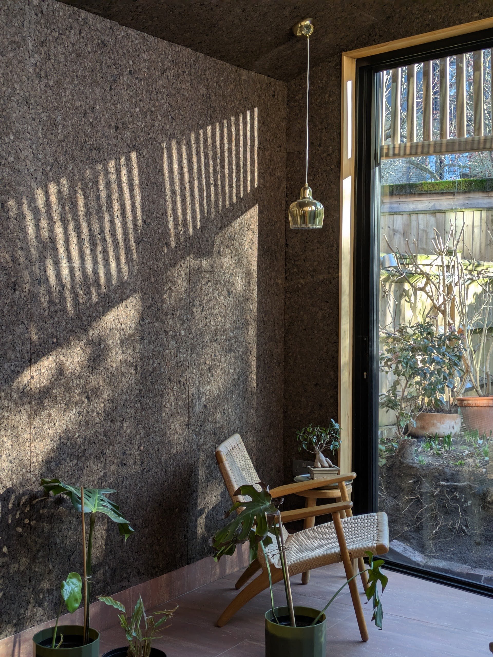 Cork is used in Pine House’s garden room, catching beautiful light from the extension into the garden. (Image by Polysmiths)