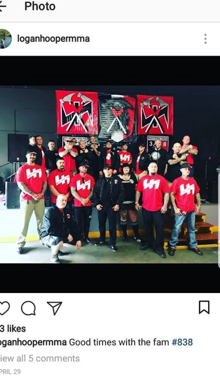 Photo caption: Tac Town Tattoo owner Jason De Simas is second from right in the front row. Tac Town piercer Irma Karr is third from right in the same row. 