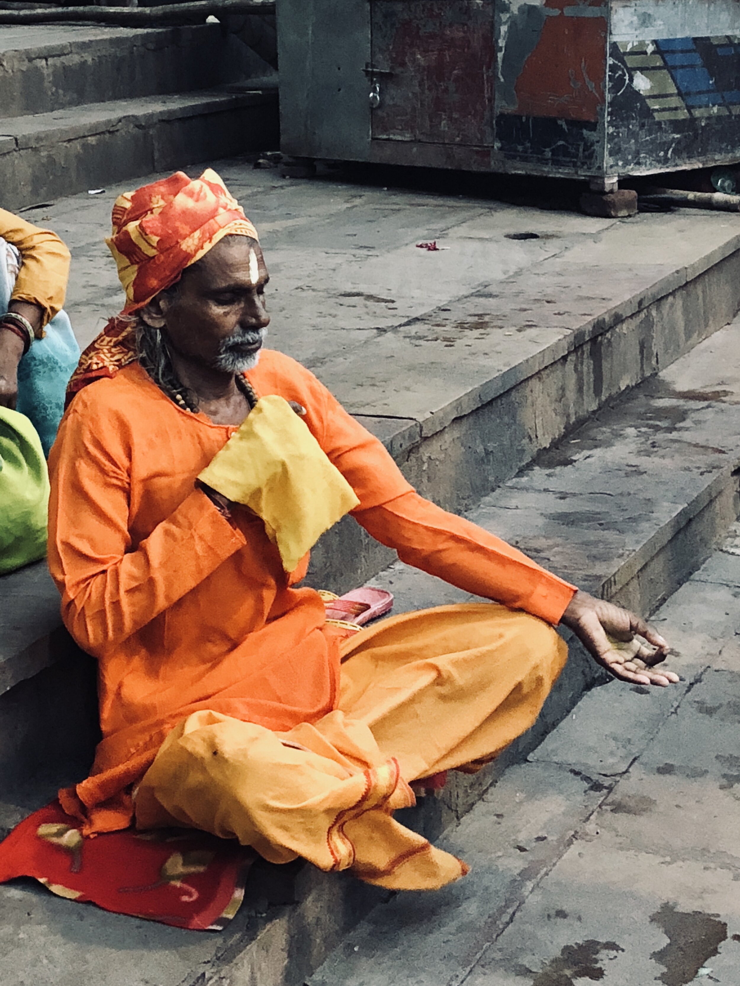 Hindu Man on the steps leading down to the Ganges River - photo by Ash Burns