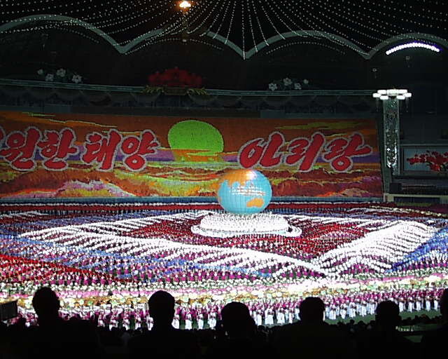 The Arirang Mass Games. About 48,000 people with flashcards are each a pixel in the background display - photo by Peter Crowcroft on WIkipedia