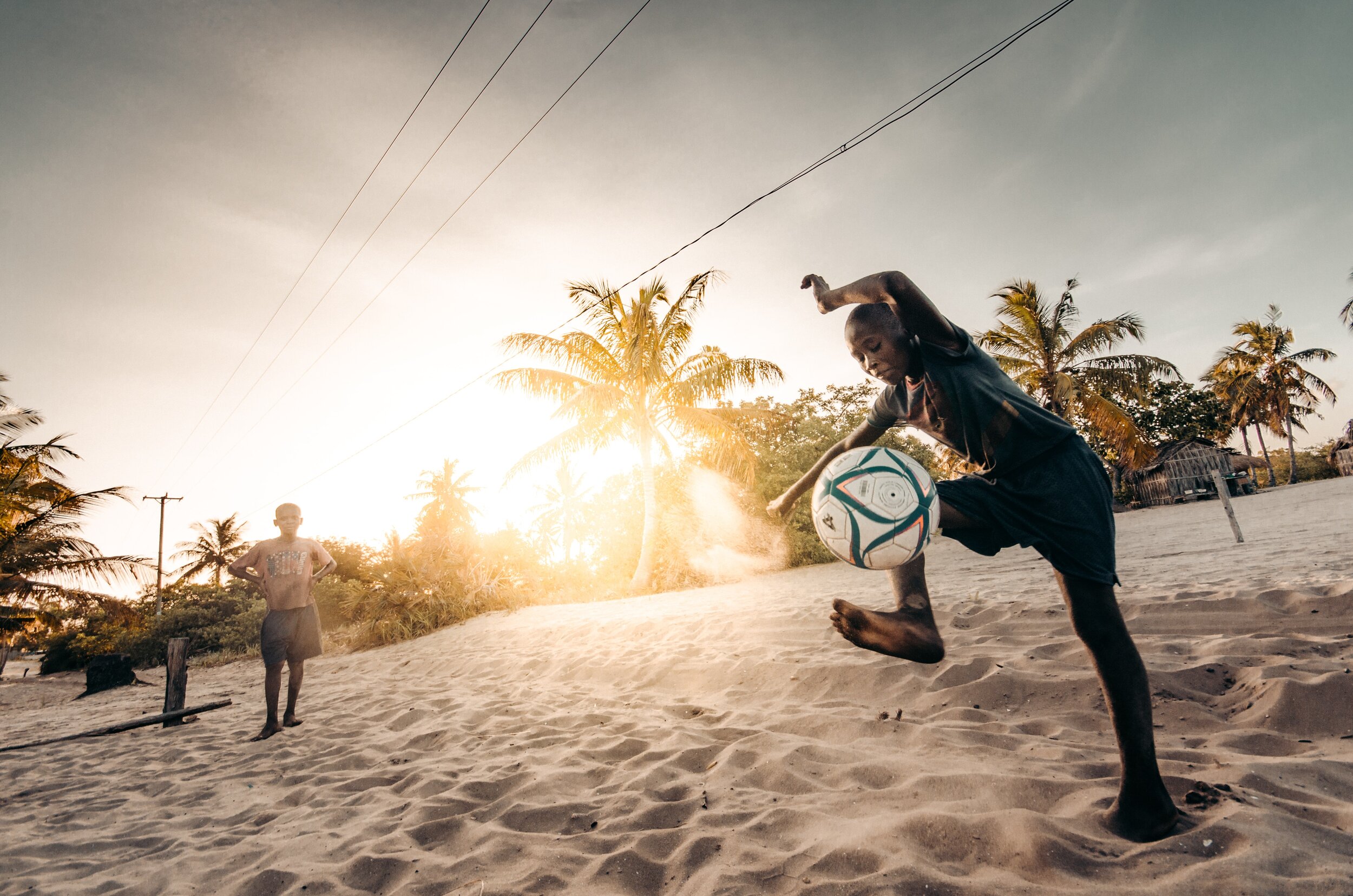 Lulu plays soccer on the beach in Mozambique on 10KDollarDay.com