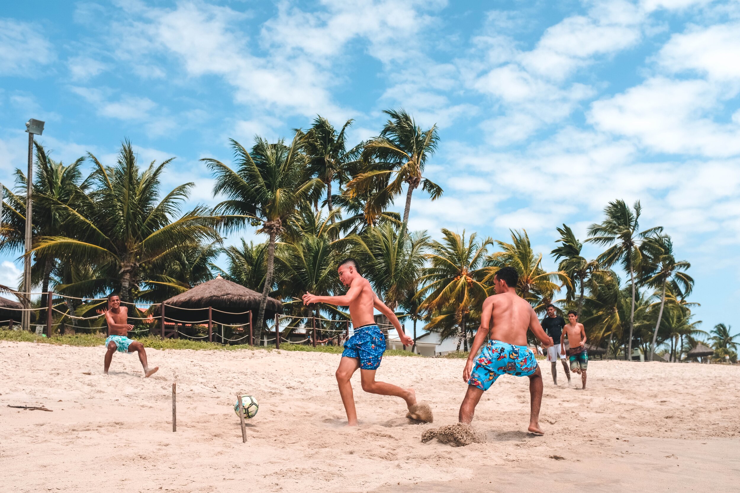 Lulu plays soccer with the locals on the beach in Mozambique on 10KDollarDay.com