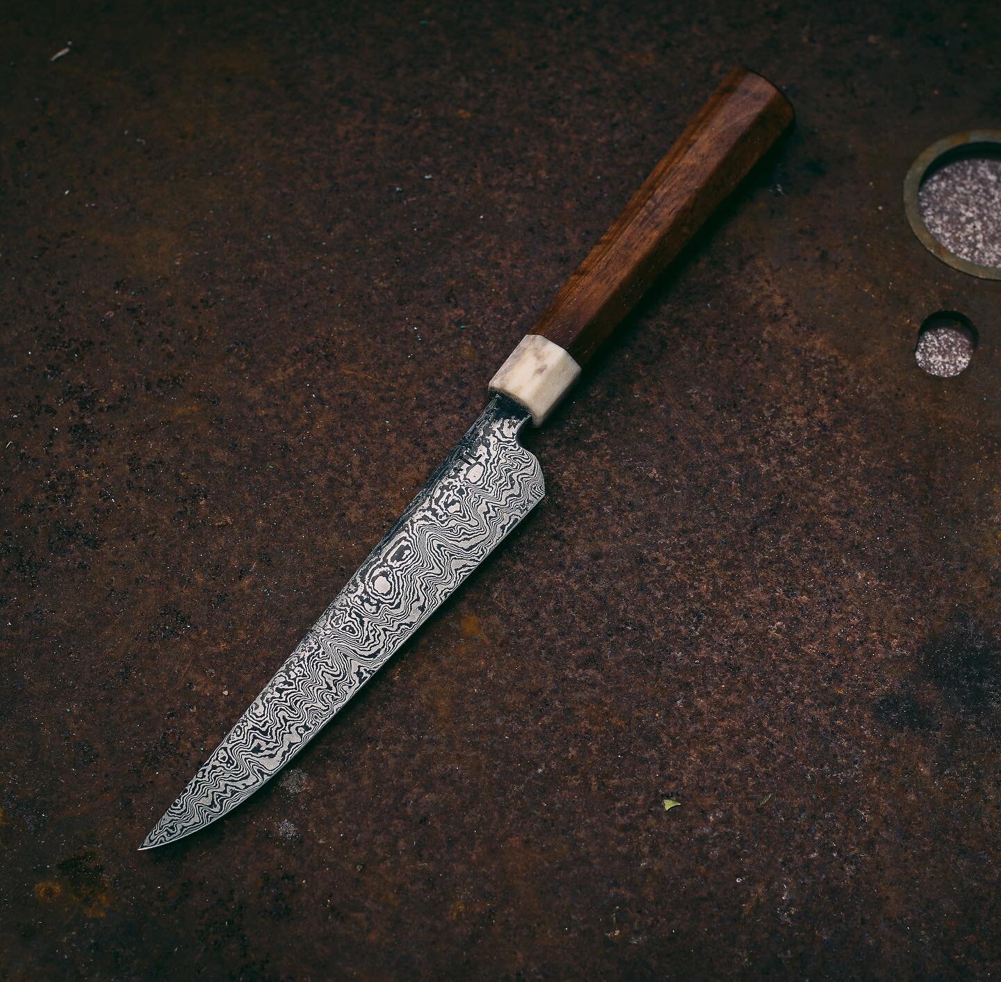 NEW KNIFE ALERT!

A new Hand-forged Damascus and Blackwood Boning Utility has just landed on our website.

What is a boning knife you ask?

A kitchen boning knife is shaped thinner than a usual kitchen knife, this helps it to remove meat from the bon