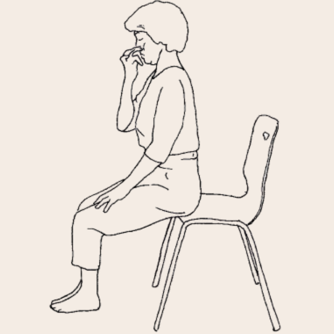 A yoga student practising pranayama on a chair