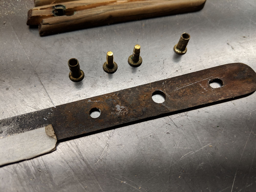  I pried the wooden handles off — there was a bit of rust beneath. The existing rivets came apart without too much fuss. 