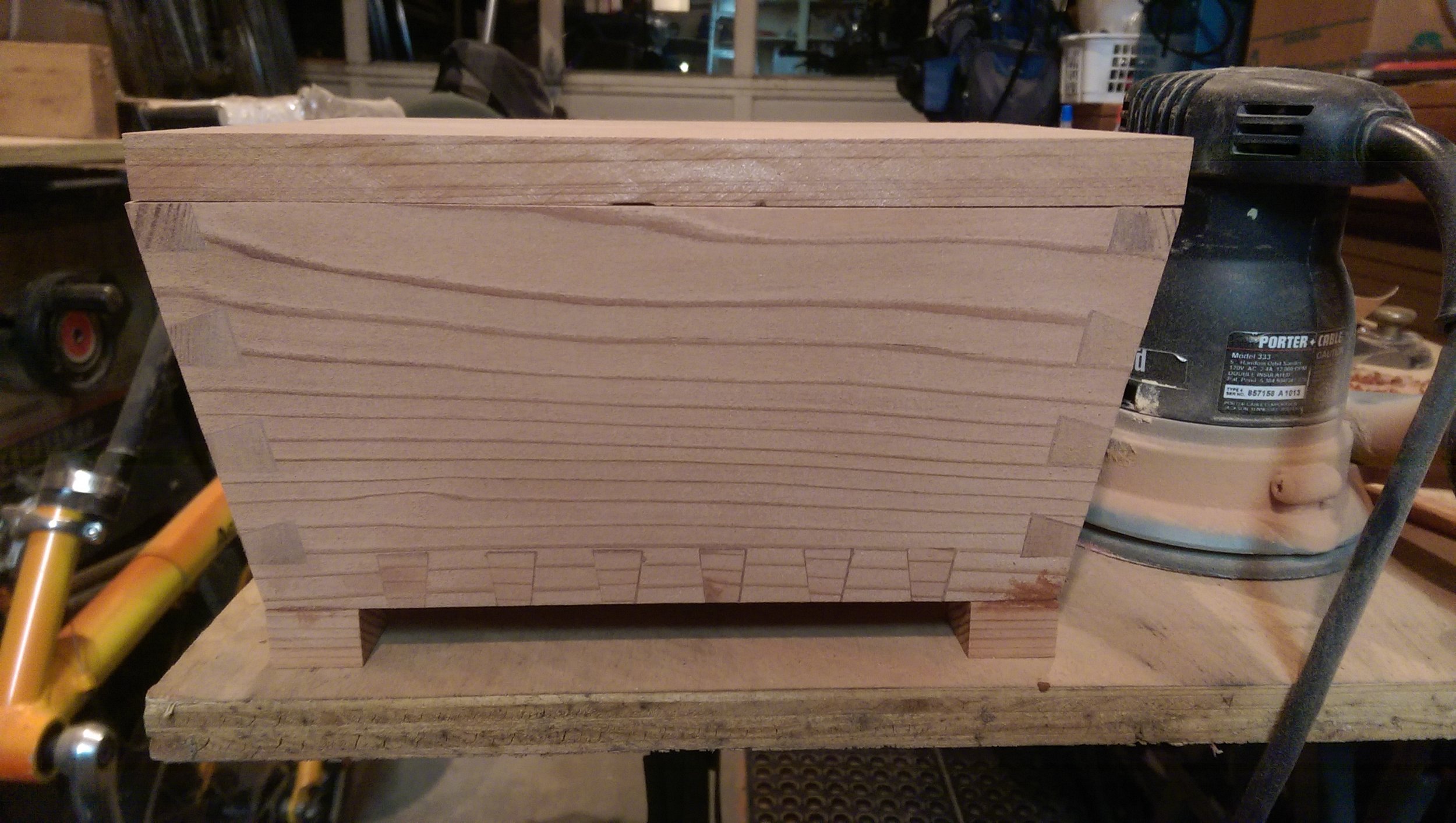  After the epoxy had hardened I sanded all of the surfaces flat with the belt sander again. Remember how some of the dovetails were too short? This meant I had to sand off a couple of millimeters from the ENTIRETY of each face.  At this point I also 