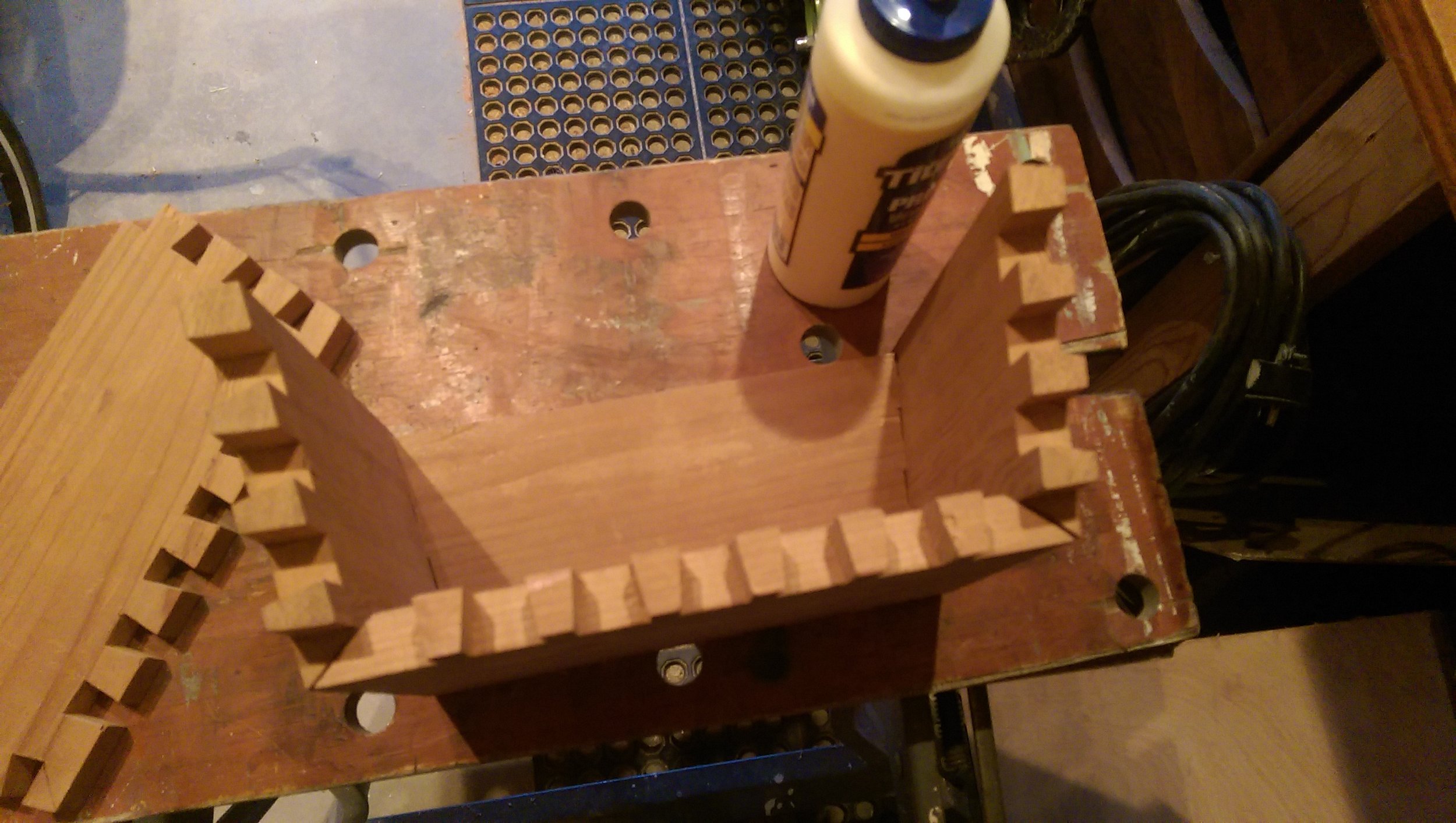  I used standard wood glue and some clamps to secure all of the pieces together. The front and back of the box hold the sides and bottom in space. The sides don’t join to the bottom. This enabled me to clamp in one direction (front-to-back) 