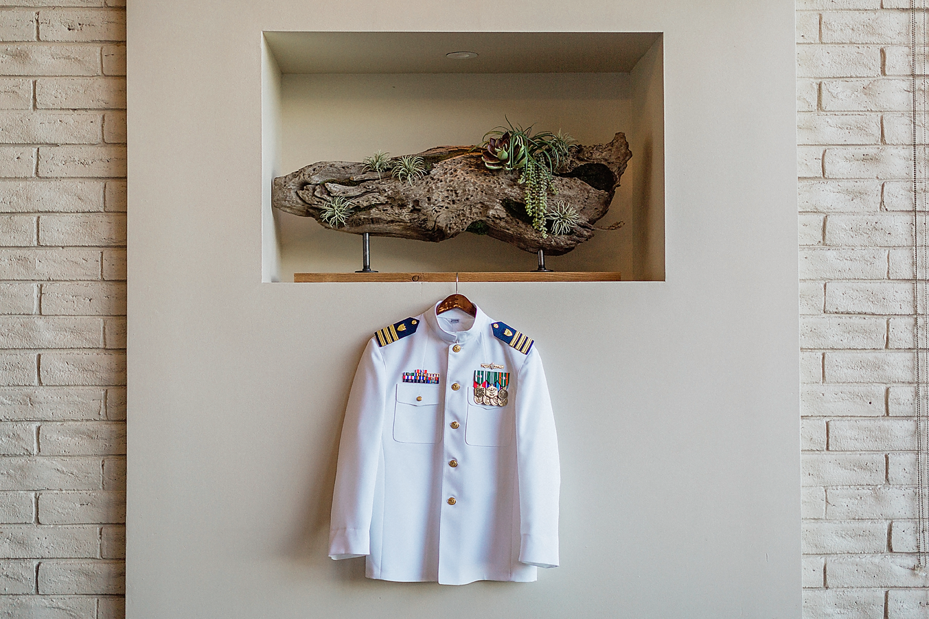 Dallas Wedding photographer Las Colinas Country Club grooms military coat hanging Kate Marie Portraiture.png